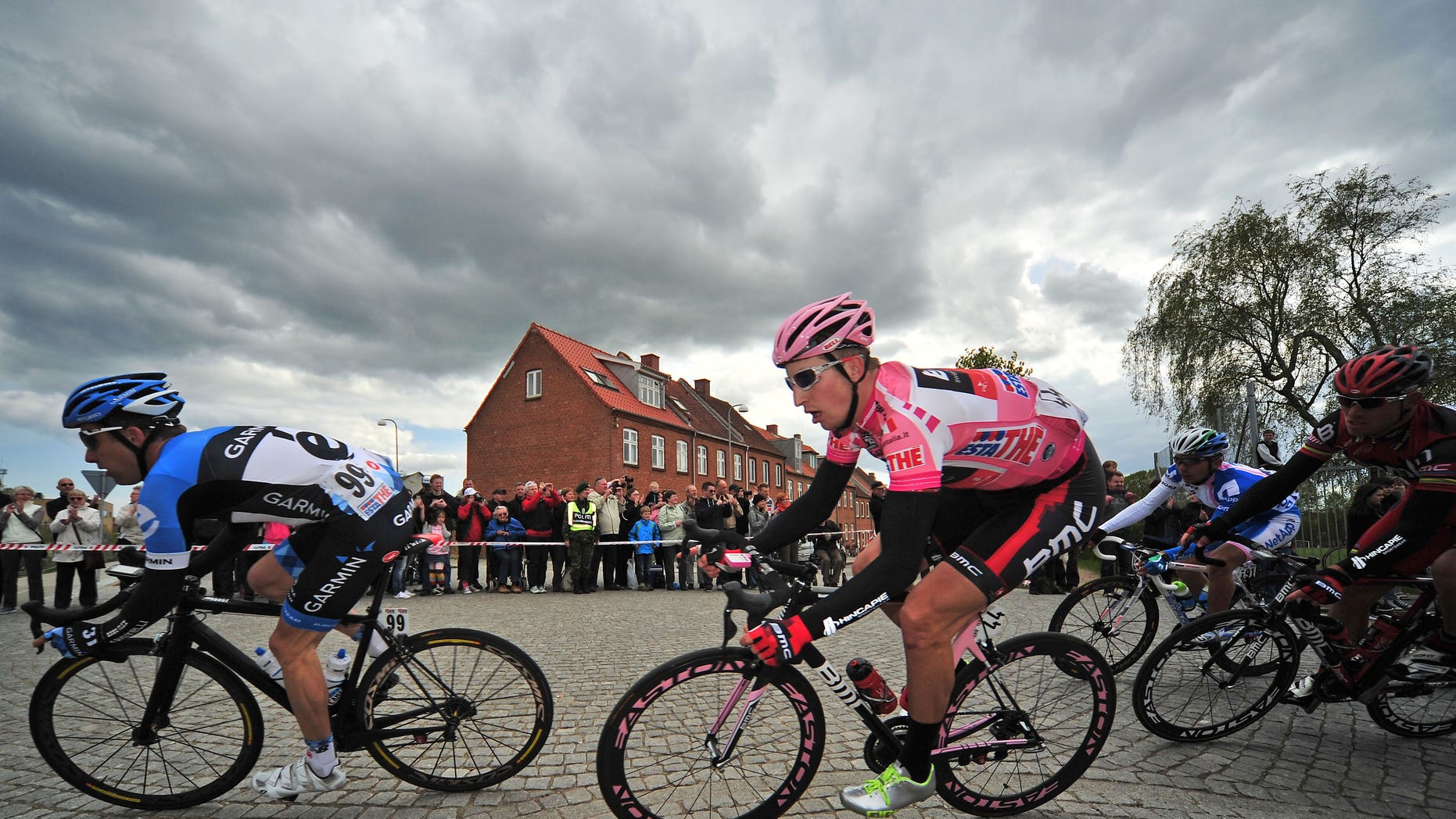 May 7, 2012: In this file photo, Taylor Phinney, second from left, of the United States, wears the overall leader's pink jersey as he rides through a corner during the third stage of the Giro d'Italia cycling race in Horsens, Denmark.