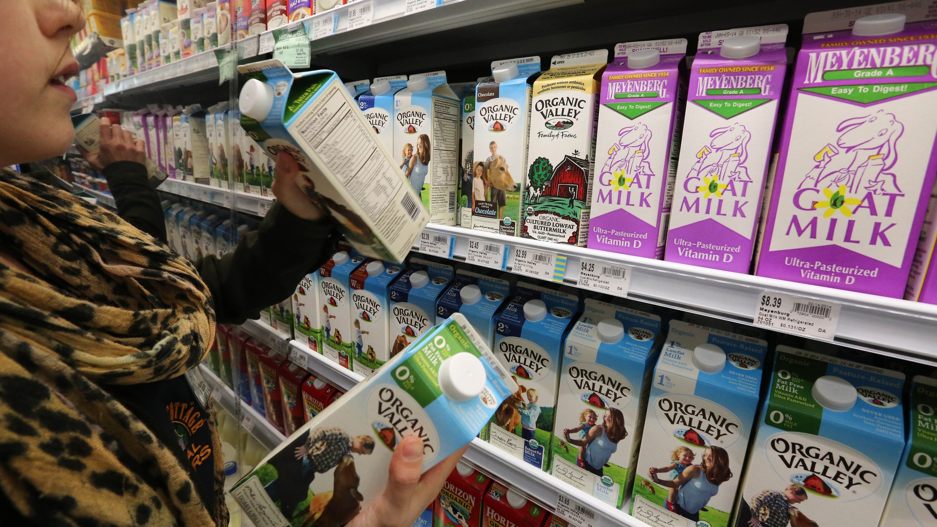 May 23, 2014: Grocery and dairy assistant Reyna DeLoge stocks dairy products that only use milk from pasture-raised cows, at Vitamin Cottage Natural Grocers, in Denver.