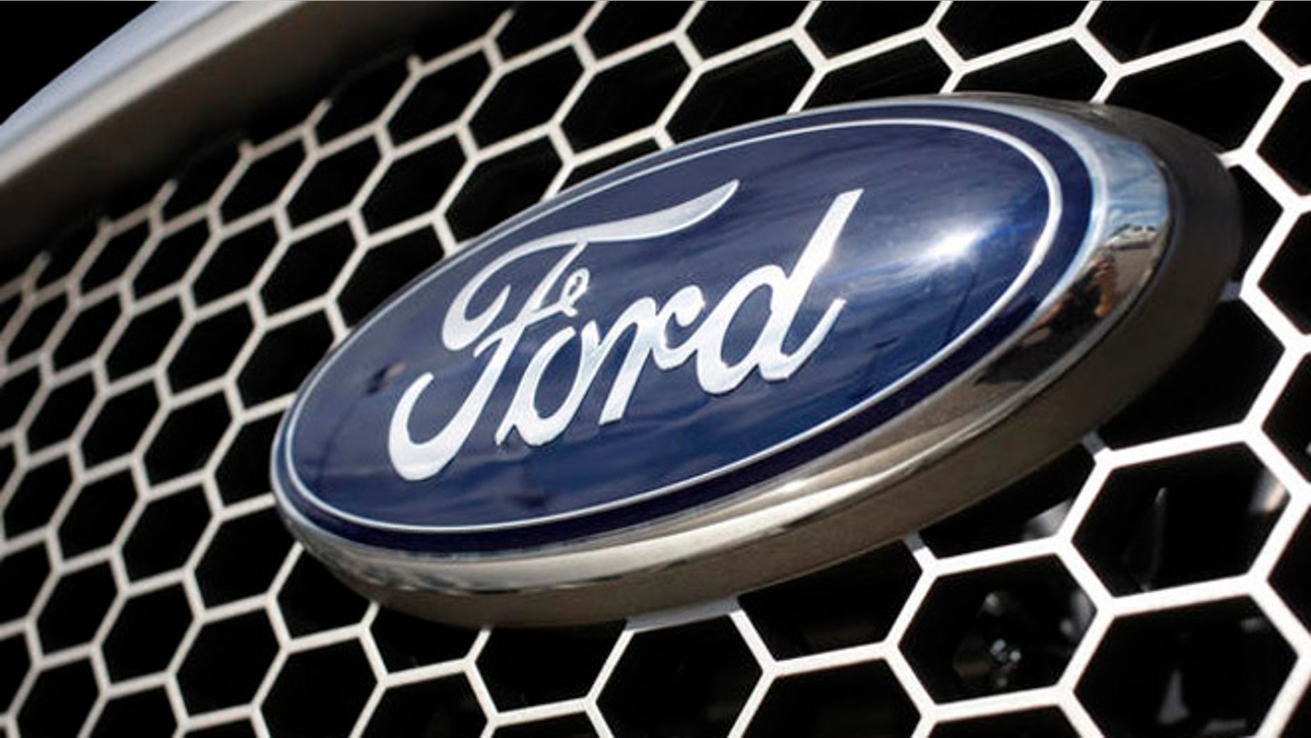 ** FILE ** In this Nov. 2, 2008 file photo, the blue oval logo of Ford Motor Company sits on the crosshatched grille of an unsold 2008 F-150 pickup truck at a Ford dealership in the southeast Denver suburb of Centennial, Colo. Ford Motor Co. on Monday, April 6, 2009 said it completed tender offers that will reduce its debt by 38 percent and shave millions of dollars off its interest costs. (AP Photo/David Zalubowski, file)