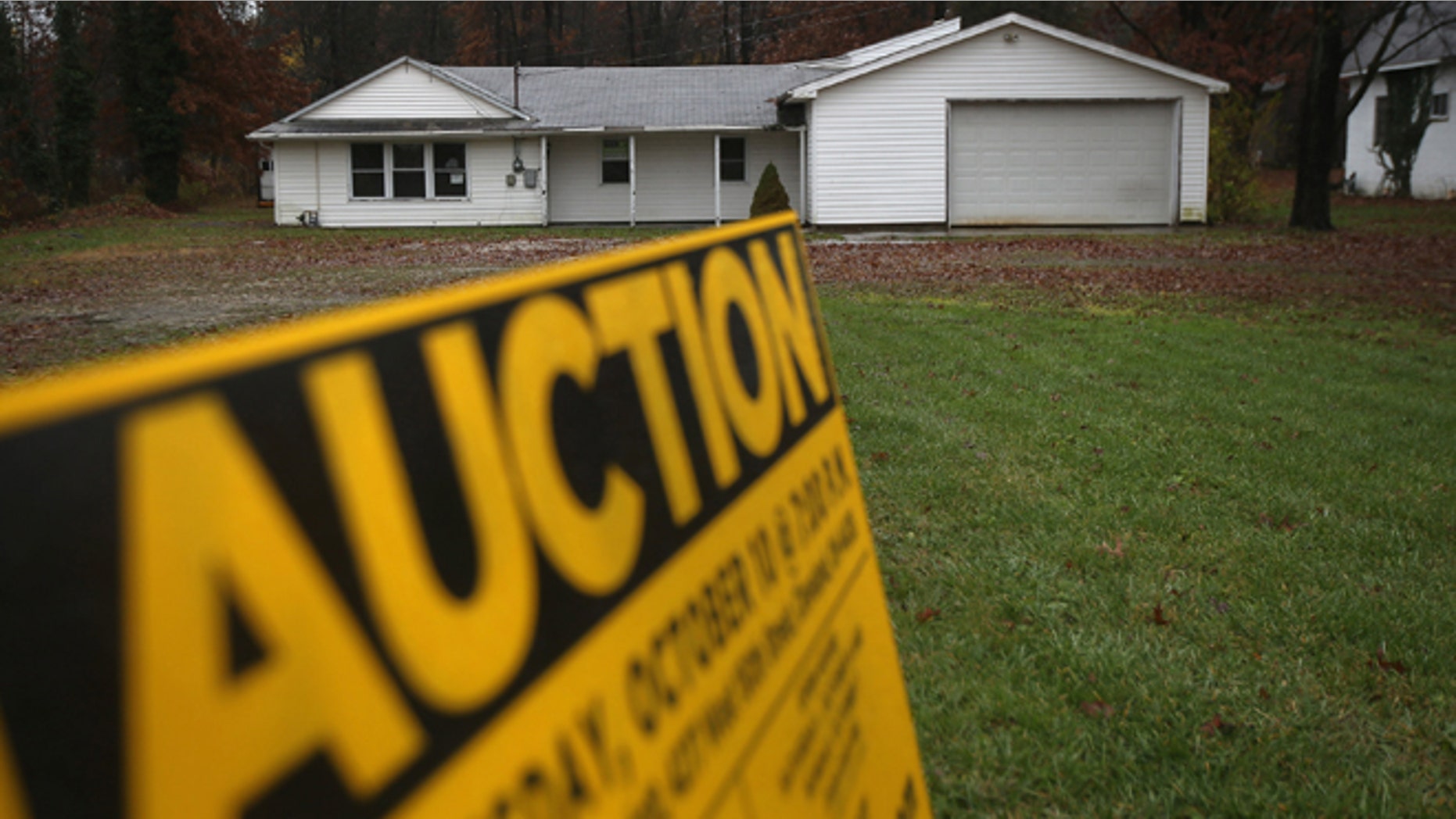 WARREN, OH - OCTOBER 29: An auction sign stands in front of a foreclosed house on October 29, 2012 in Warren, Ohio. Political analysts have predicted Ohio voters could potentially provide the winning votes in the Electoral College in the upcoming Presidential election. (Photo by John Moore/Getty Images)