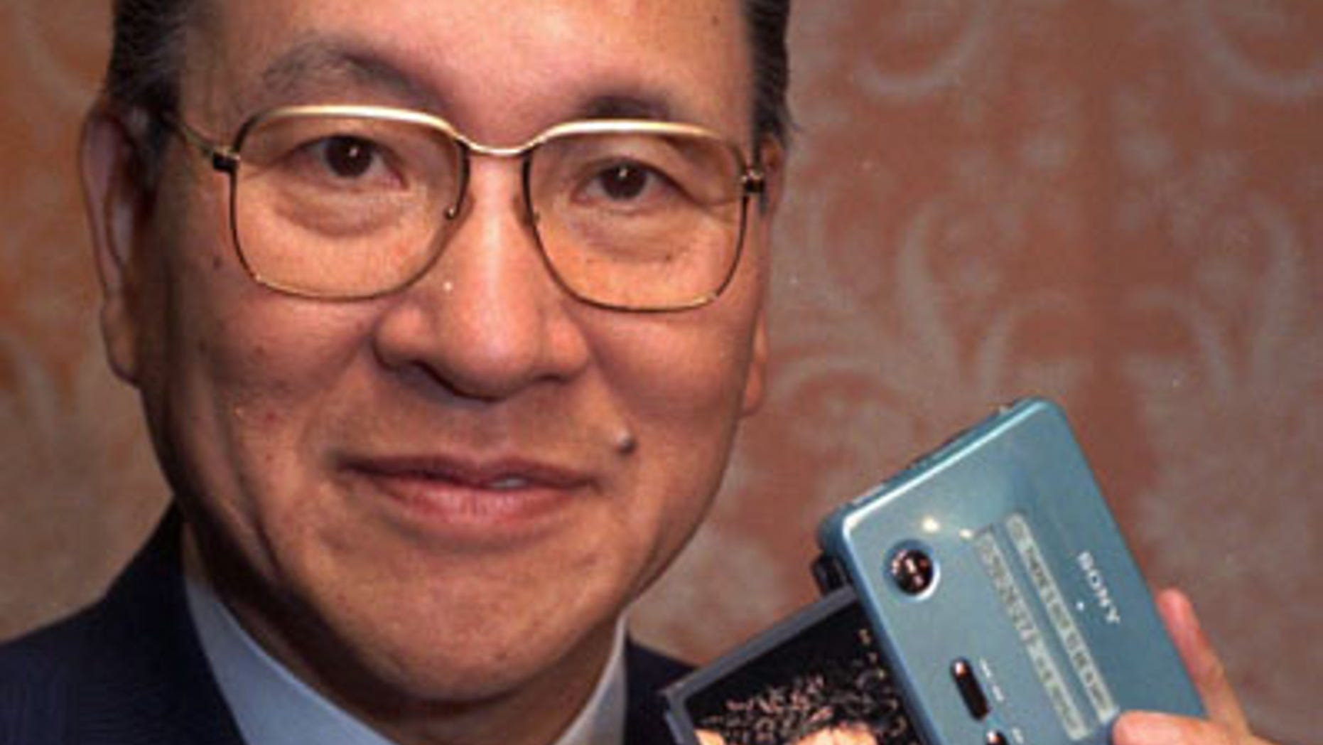 In this May 1991 file photo, former president and chairman of Sony, Norio Ohga, holds a Sony Mini Disc in New York. Sony says Ohga, credited with developing the compact disc, has died Saturday, April 23, 2011. He was 81. Sony Corp. Chairman Howard Stringer said Ohga helped redefine the Japanese manufacturer not only as an electronic hardware company but helped it also expand into software or entertainment. (AP/File)