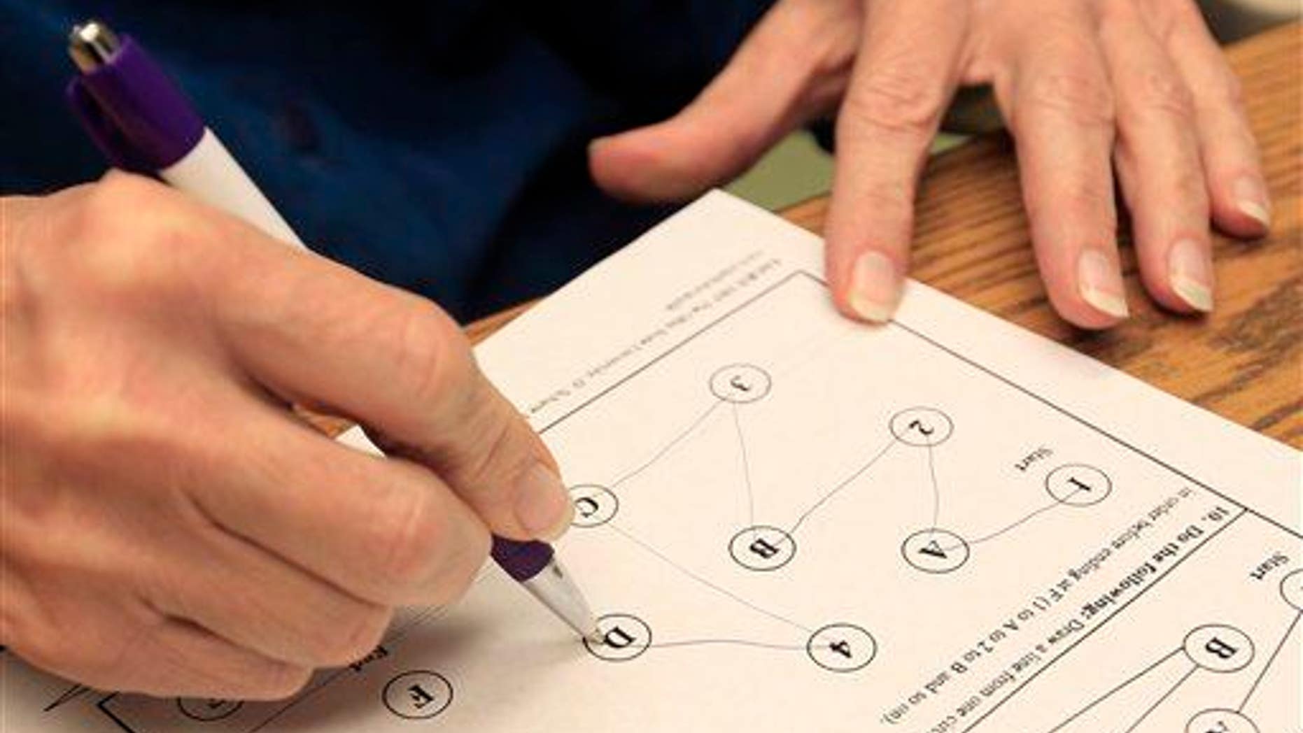 Kathleen Sanford performs neurological cognitive tests on Dec. 17, 2012, in Columbus, Ohio.