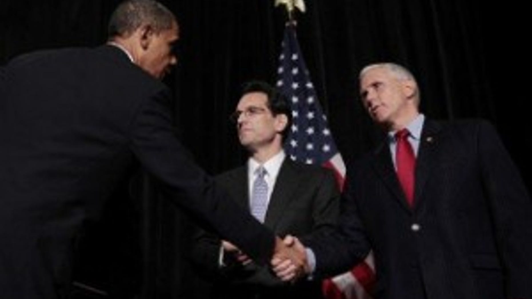 President Obama shakes hands with Rep. Mike Pence (R-IN), as House Minority Whip Eric Cantor (VA) looks on at the GOP House Issues Conference in Baltimore. (AP Photo)