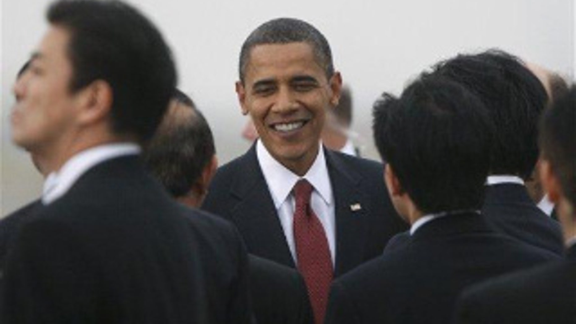 President Obama is greeted at Haneda Airport in Tokyo. (AP Photo)