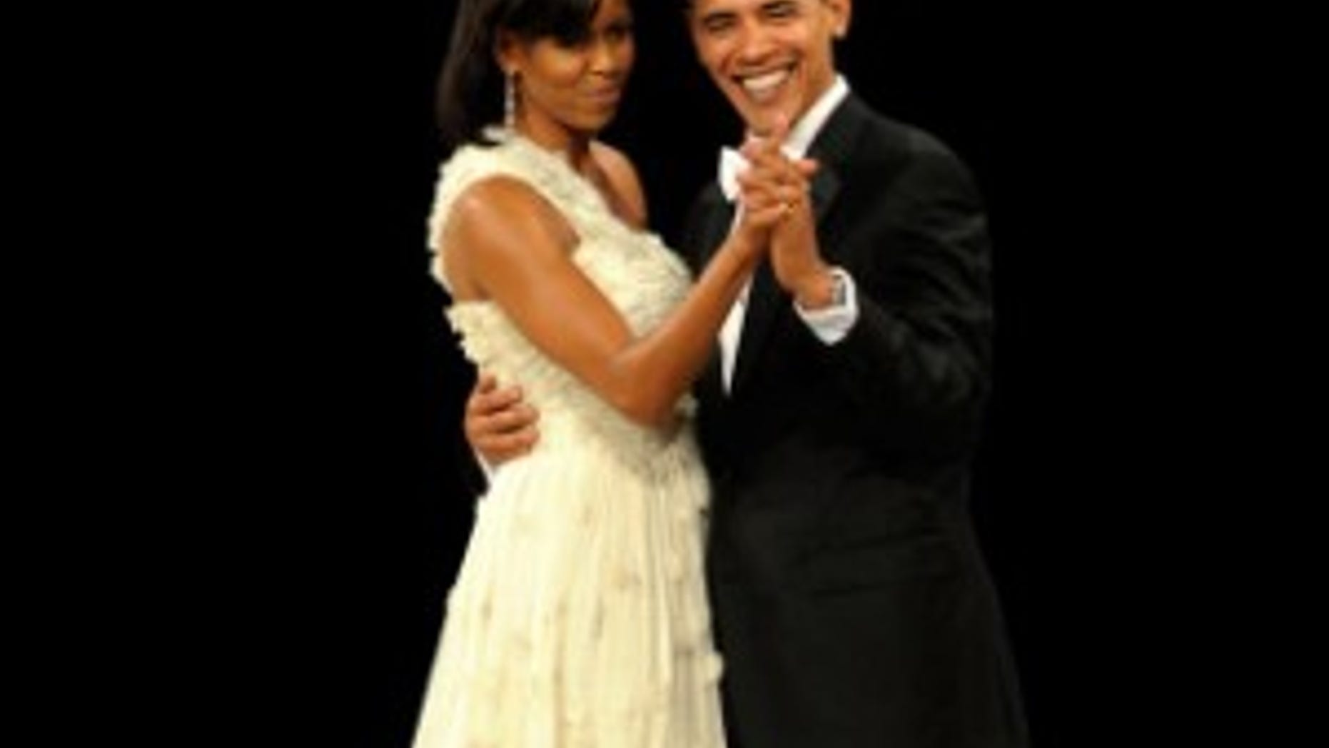 Michelle Obama dances with her husband at an inaugural ball. January 20, 2009/AP PHOTO