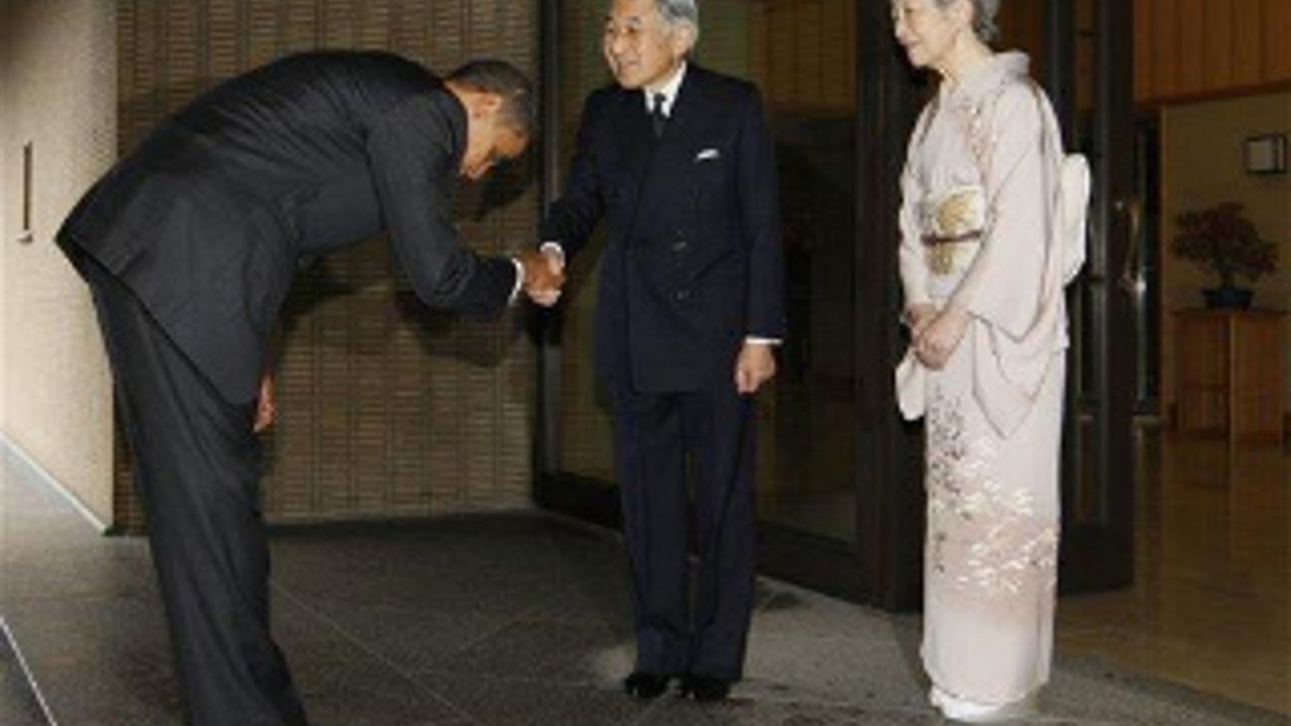 President Obama bows as he is greeted by Japanese Emperor Akihito and Empress Michiko at the Imperial Palace in Tokyo. (AP Photo)