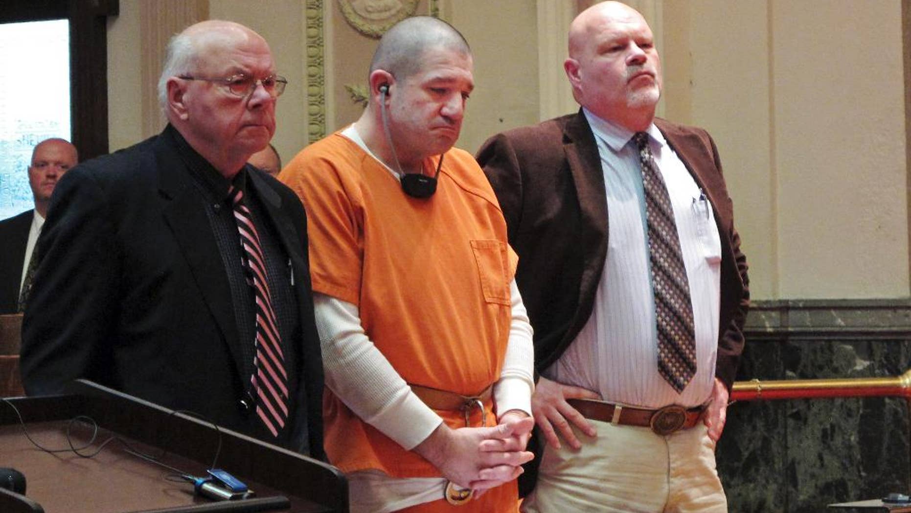FILE - In this Jan. 14, 2015 file photo, Donald Hoffman, 41, stands between defense attorneys Robert Whitney, left, and Rolf Whitney as he pleads guilty to aggravated murder in a deal with prosecutors in Bucyrus, Ohio. Video of Hoffman's police interviews was released Friday, Feb. 13, 2015, and offers some explanation for the slayings, mostly a combination of drugs, money and anger. (AP Photo/Kantele Franko, File)