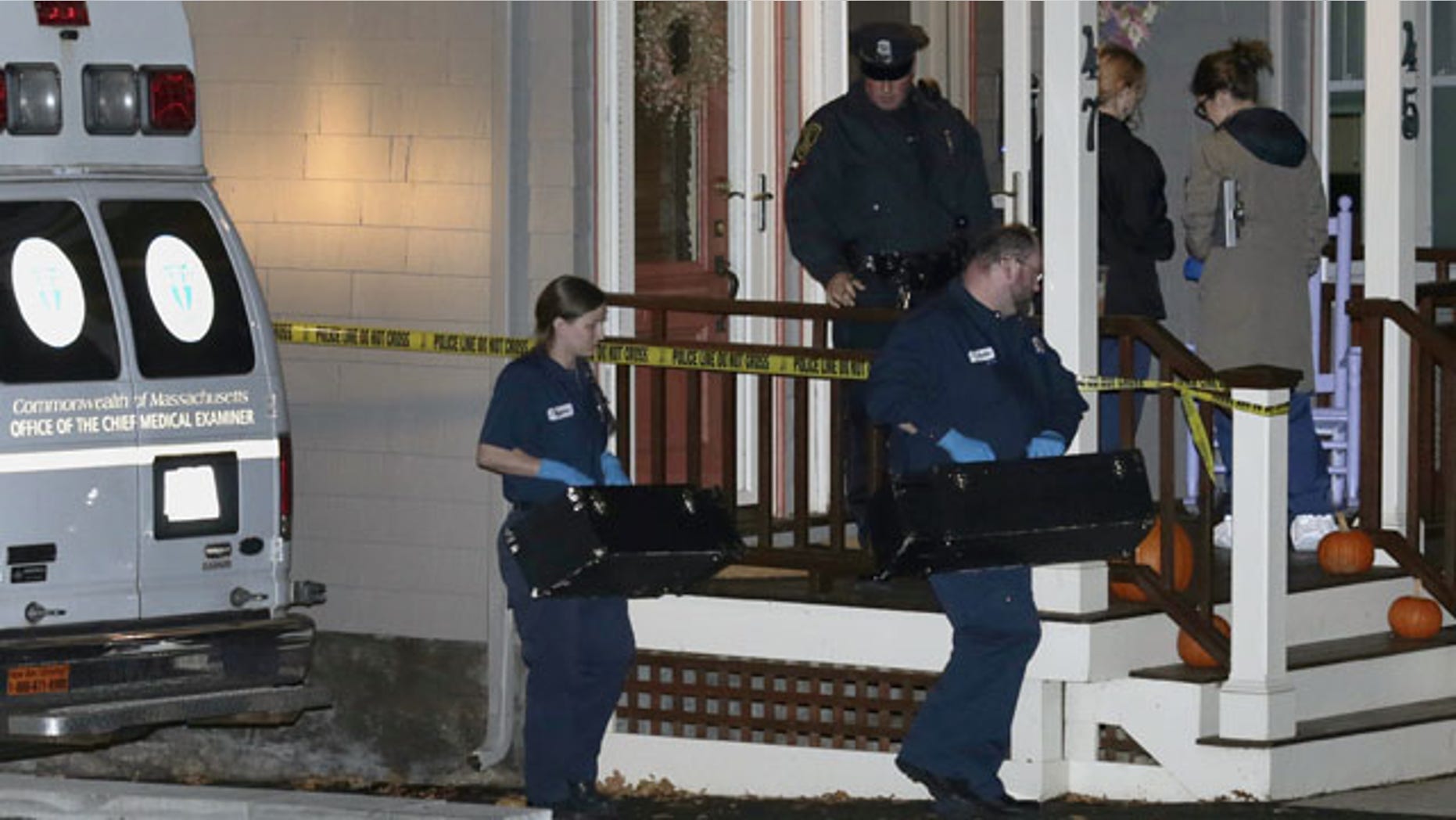 November 18, 2013: Workers from the Massachusetts medical examiner's office carry two small boxes to a home in a neighborhood of Arlington, Mass.