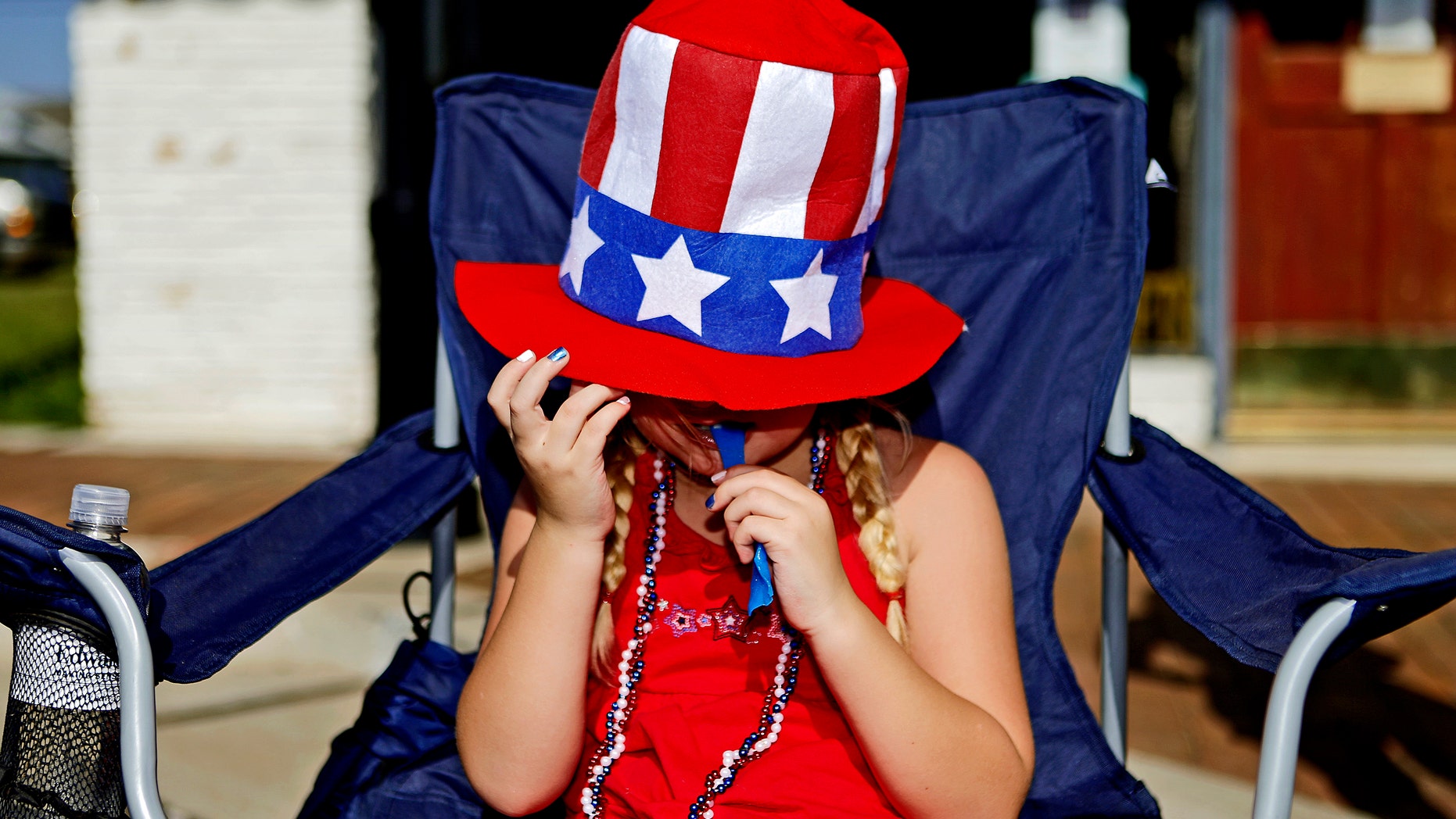 July 4, 2012: Hannah Hargis, 6, of Edmond enjoys a snack as she watches the LibertyFest Fourth of July Parade in Edmond, Okla.