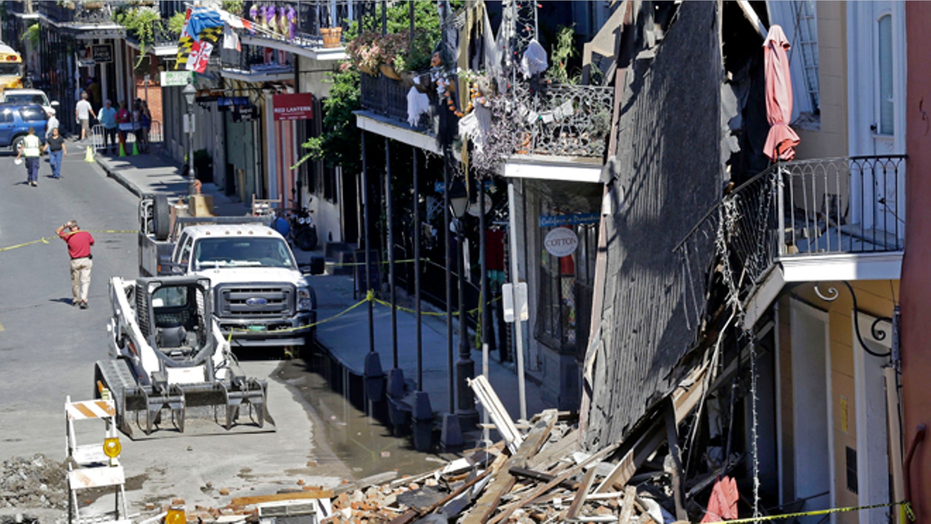Oct. 22, 2014: In this photo, pedestrians walk by a three-story, brick-and-cypress building that collapsed in the historic French Quarter section of New Orleans. (AP)