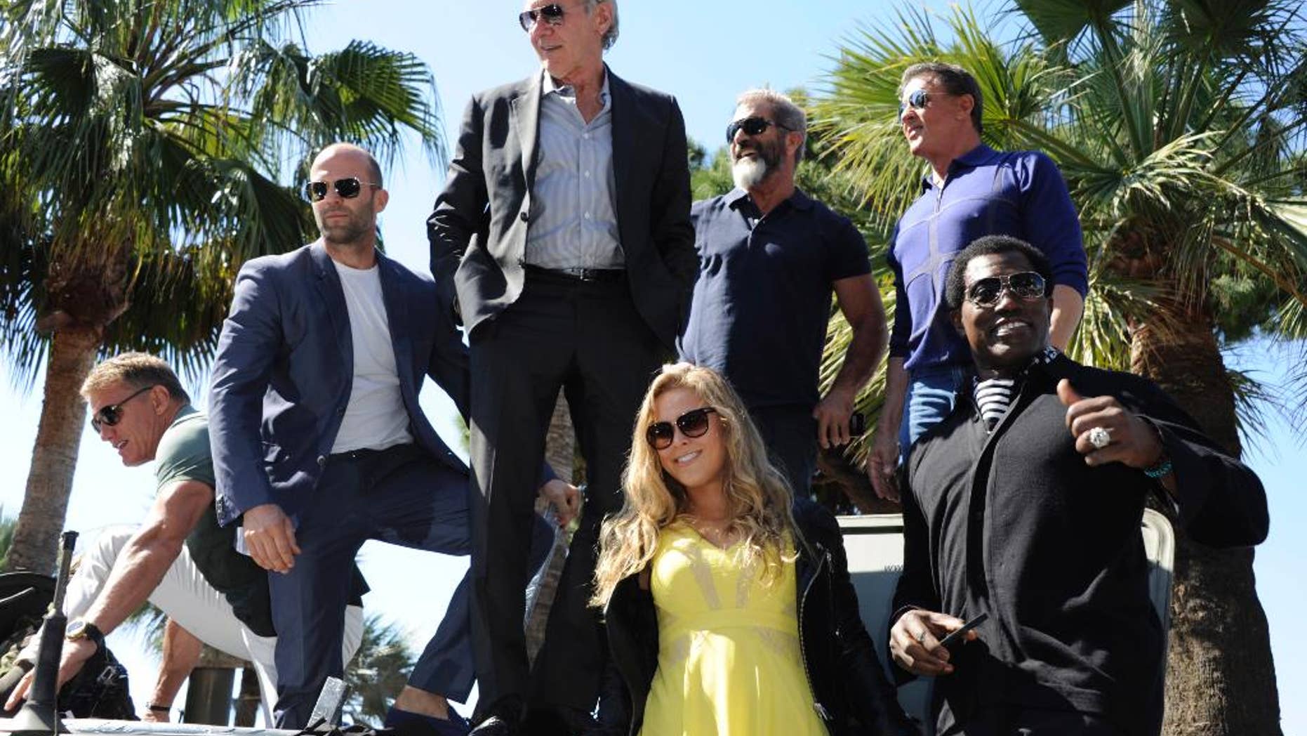 From left, Dolph Lundgren, Jason Statham, Harrison Ford, Mel Gibson, Sylvester Stallone, Wesley Snipes and Ronda Rousey during a photo call for "The Expendables 3" at the 67th international film festival, Cannes, southern France.