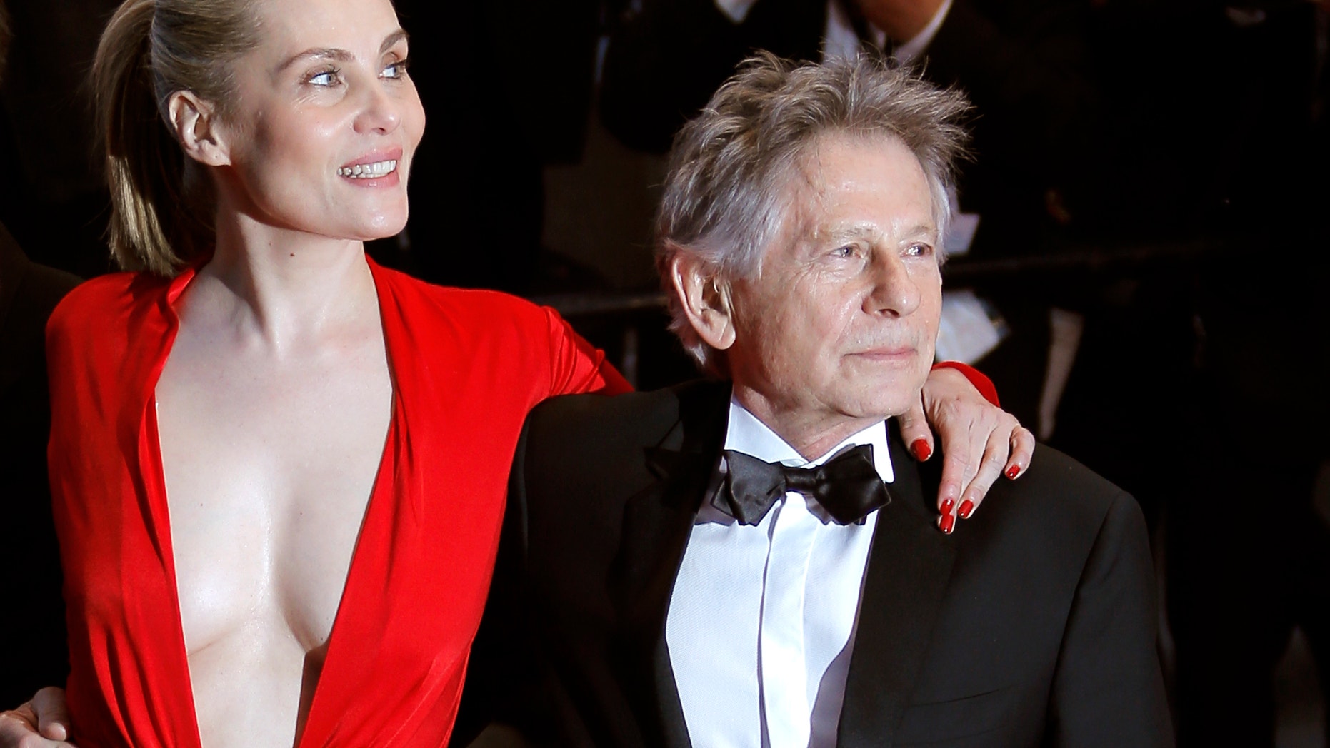 From left, actors Mathieu Amalric, Emmanuelle Seigner and director Roman Polanski leave following the screening of Venus In Fur at the 66th international film festival, in Cannes, southern France, Saturday, May 25, 2013. (AP Photo/Lionel Cironneau)