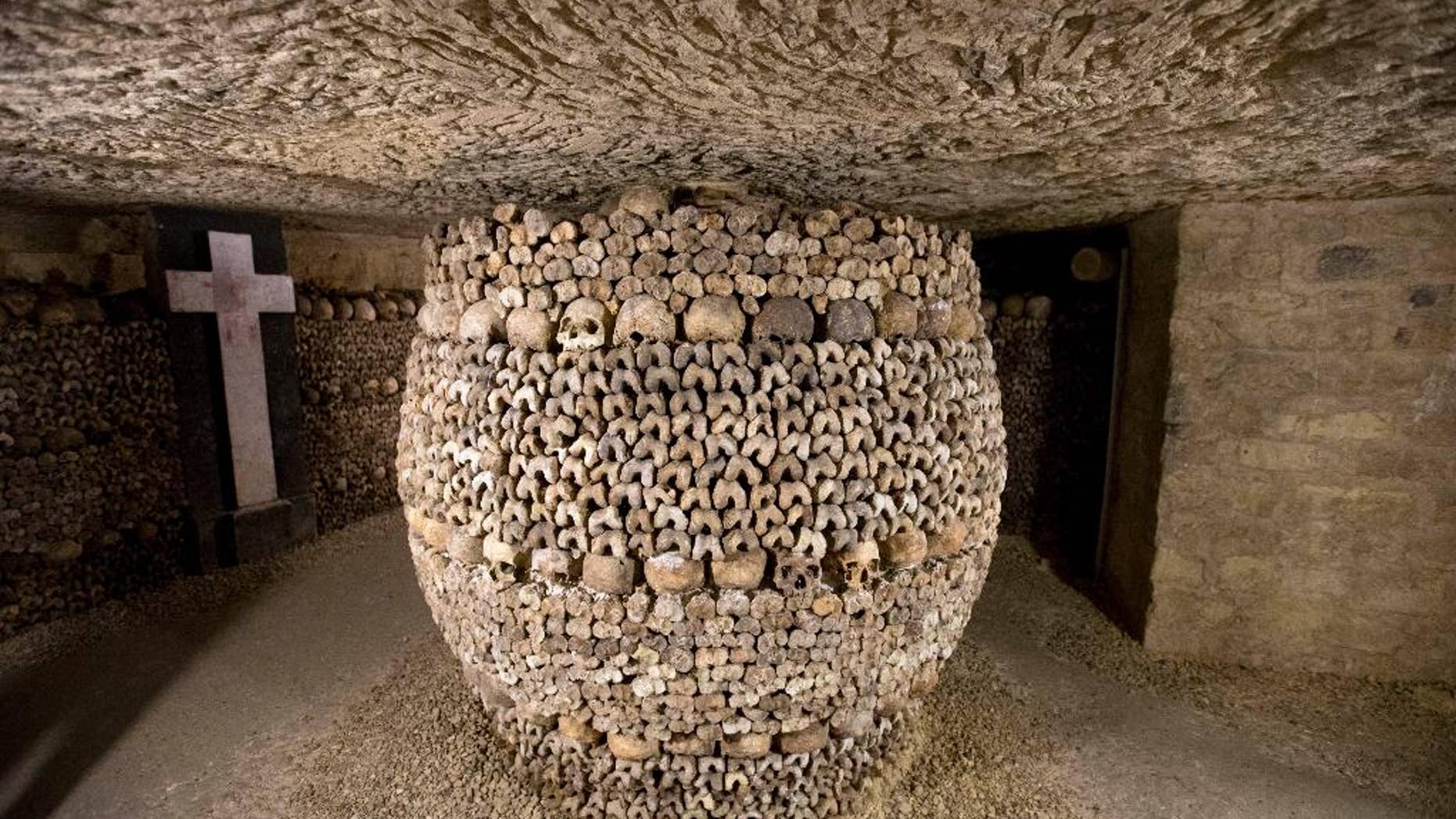 In this photo taken Tuesday, Oct. 14, 2014, skulls and bones are stacked at the Catacombs in Paris, France. The subterranean tunnels, stretching 2 kilometers (1.24 miles), cradle the bones of some 6 million Parisians from centuries past and once gave refuge to smugglers. The site used to close at 5 p.m., but is now staying open until 8 p.m. The change is mainly aimed at allowing more people to visit and reducing long lines, since it can only hold a limited number of people at a time and visits can’t be reserved in advance. (AP Photo/Francois Mori)