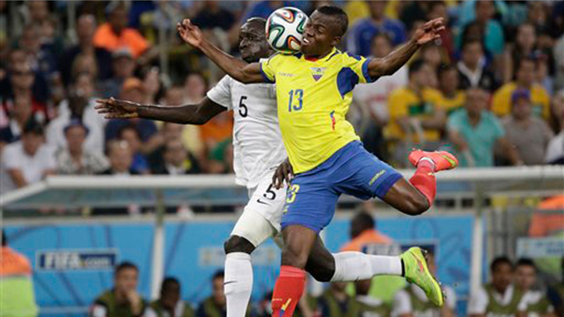 France's Mamadou Sakho, left, and Ecuador's Enner Valencia challenge for the ball during the group E World Cup soccer match between Ecuador and France at the Maracana Stadium in Rio de Janeiro, Brazil, Wednesday, June 25, 2014. (AP Photo/Christophe Ena)