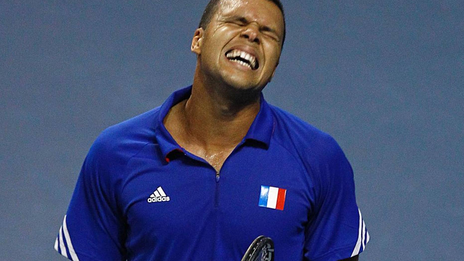 French tennis player Jo-Wifried Tsonga grimaces after missing a point during his single match against German player Peter Gojowczyk, in the quarterfinals of the Davis Cup in Nancy, eastern France, Friday April 4, 2014. France plays against Germany from Friday April 4 to Sunday April 6. (AP Photo/Remy de la Mauviniere)