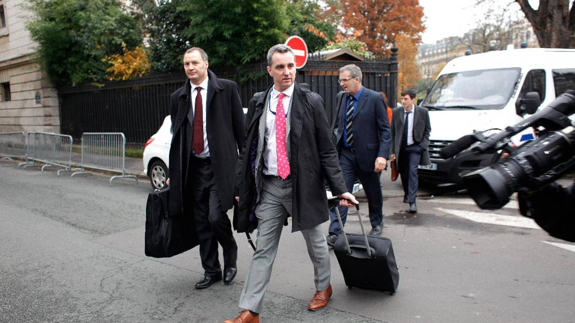 Declan Costello of the European Commission, center, and Klaus Masuch of the European Central Bank , second from right, arrive for a meeting with Greek government officials, in Paris, Tuesday, Nov. 25, 2014. Greek officials and debt inspectors meet in Paris to restart a review of the nation's financial reforms before the bulk of the country's bailout loans end this year. (AP Photo/Thibault Camus)