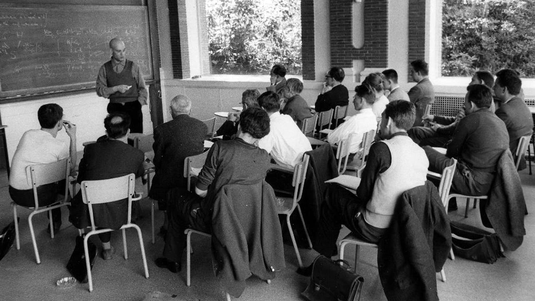 This photo provided Friday, Nov.14, 2014 by the IHES (High Scientific Studies Institute) shows mathematician Alexandre Grothendieck, at the blackboard, during a lesson, south of Paris, in the 1960's. Grothendieck, an opinionated and reclusive German-born giant of 20th-century mathematics who shunned accolades and supported pacifist and environmental causes, has died, the French presidency said Friday. He was 86. (AP Photo/IHES)