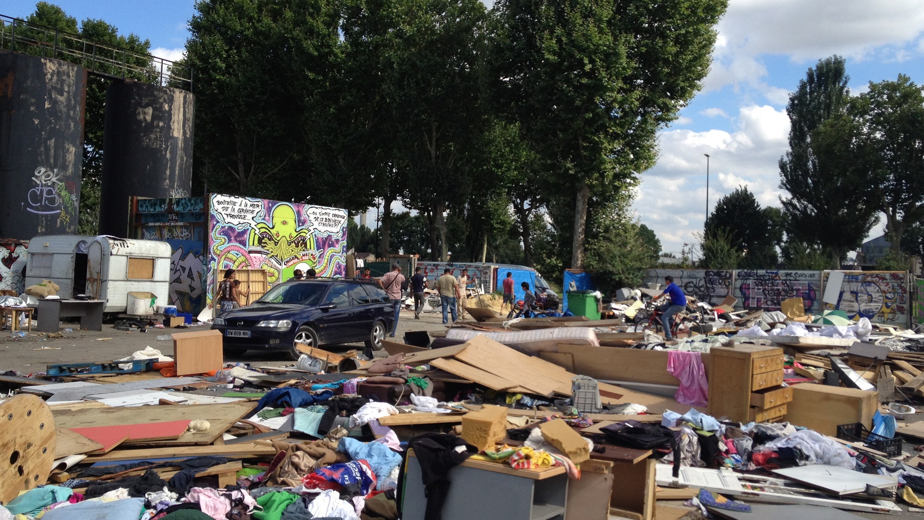 This is an image taken Thursday, Aug. 9, 2012 of the abandoned lot that Gypsies had made their home for five months in Gennevilliers, outside Paris, shortly after they learned the encampment would be demolished. The Gypsy camps lack electricity and running water. Grocery carts become makeshift grills. Rats run rampant and fleas gnaw on young and old alike. It's a life that modernity has bypassed, compounded by a dismal economy that has stretched from their homeland in Romania to a France that wants them to go somewhere anywhere else. (AP Photo/ Lori Hinnant )