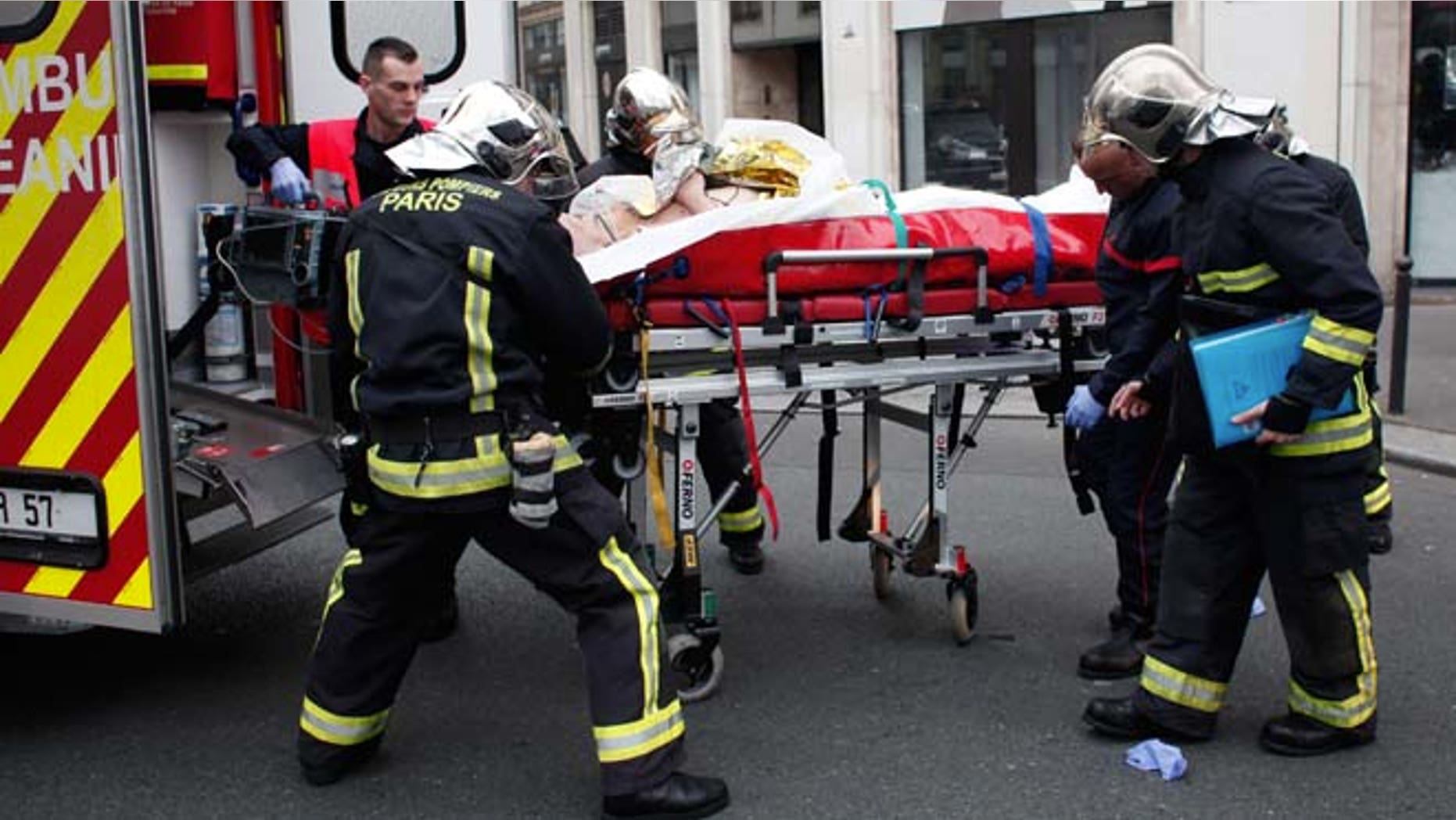 Jan. 7, 2015: An injured person is transported to an ambulance after a shooting, at the French satirical newspaper Charlie Hebdo's office, in Paris. (AP)