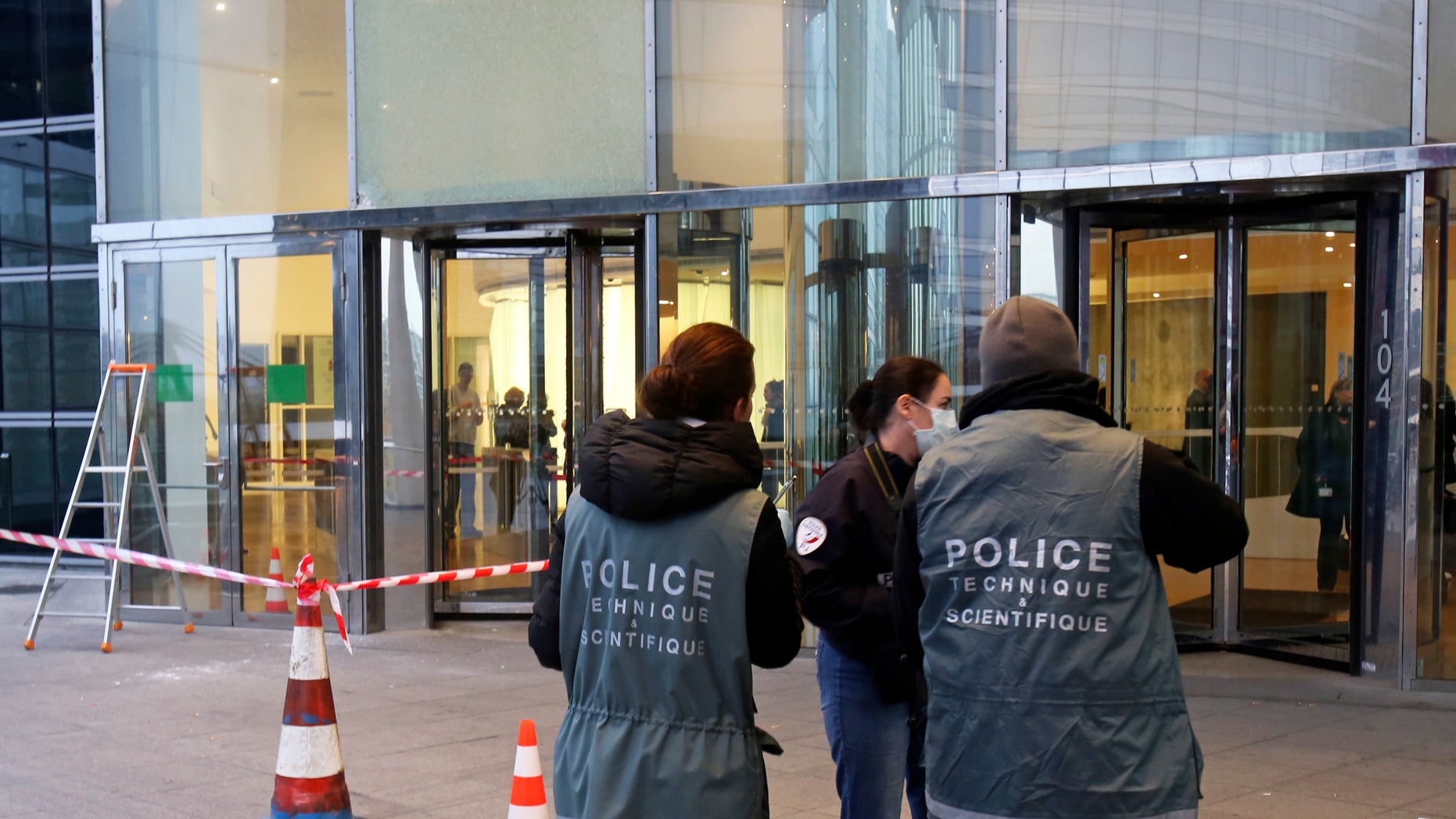 Nov. 18, 2013 - Police officers work at the entrance of the Societe General Bank headquarters in La Defense business district, west of Paris. Soon after a shooting at newspaper Liberation, shots were fired at the headquarters of a major French bank west of Paris, and a gunman briefly took a man hostage nearby. The Paris police headquarters said that it is not clear whether the three incidents are linked, but that authorities are increasing security in all three places as well as media offices around Paris.