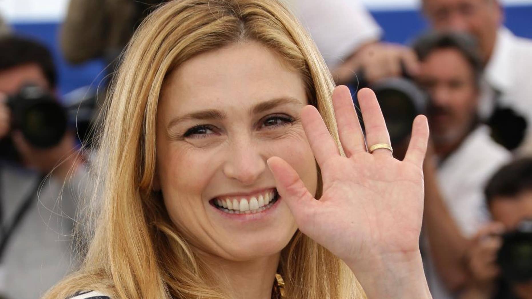 FILE - In this May 21, 2015 file photo, French actress and producer Julie Gayet poses for photographers during a photo call for the film Comoara (Treasure), at the 68th international film festival, Cannes, southern France. In her first appearance at an official ceremony in the presence of her partner President Francois Hollande, Gayet was invited Thursday June 18, 2015 to accompany her grandfather, Alain Gayet at a ceremony of commemoration of Charles de Gaulle’s Appeal of June 18 at the Mont Valerien memorial west of Paris (Photo by Joel Ryan/Invision/AP, File)