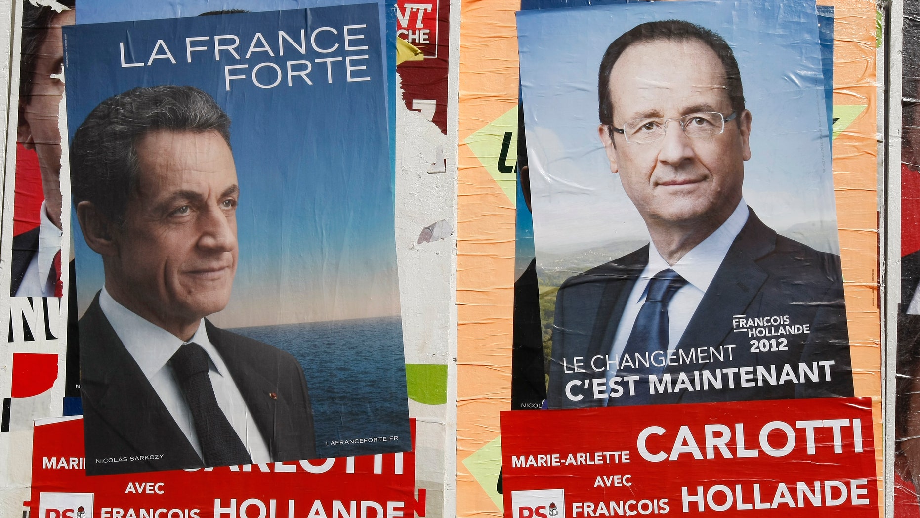 April 26, 2012: Posters of France's Socialist Party candidate Francois Hollande, and France's President and candidate for re-election, in the 2012 French presidential election, Nicolas Sarkozy, are posted in front of a school, in Marseille, southern France.