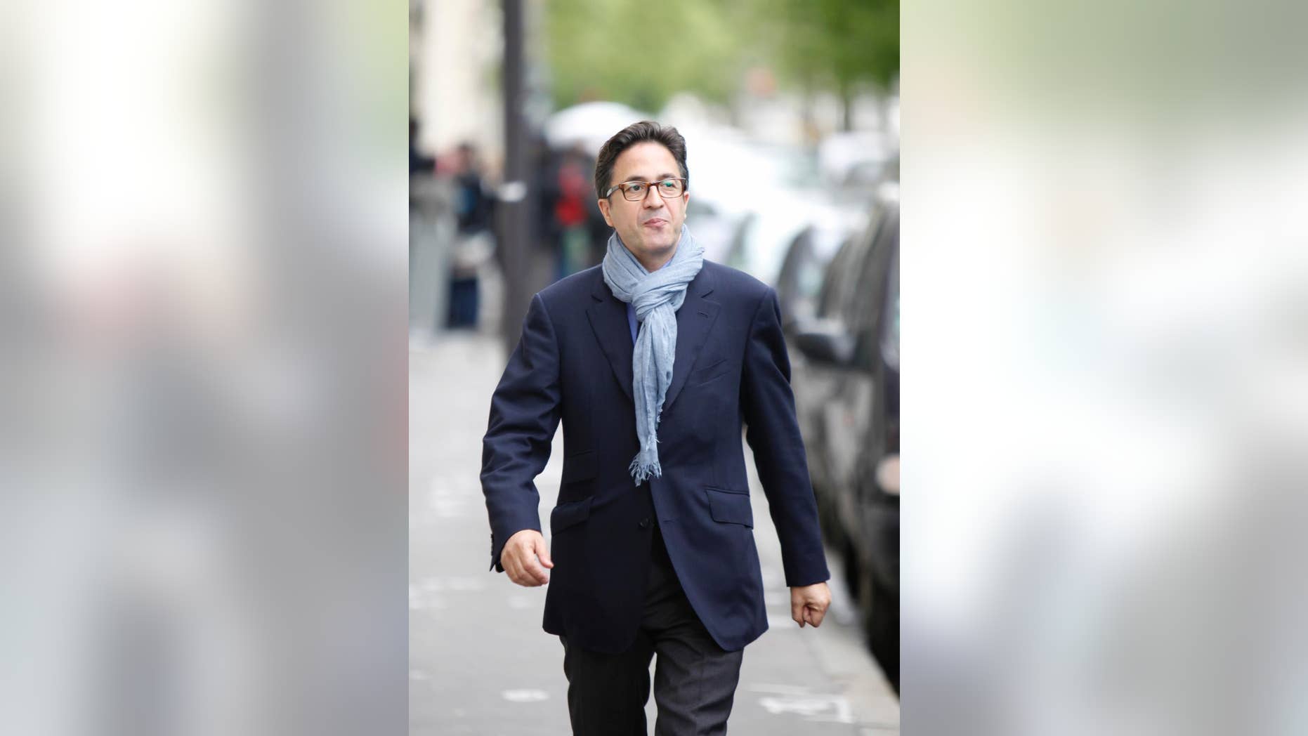 FILE - In this Wednesday, May 9, 2012 file photo, Francois Hollande's political adviser Aquilino Morelle smiles as he walks to a meeting of the Socialist group at the National Assembly in Paris. The French president’s top adviser has resigned following allegations of a past conflict of interest, striking a new blow to already unpopular Francois Hollande. Aquilino Morelle - Hollande’s political adviser and head of communication staff - announced his resignation Friday, an official in president’s office said. Morelle has denied allegations by news website Mediapart of a conflict of interest while he worked for the government pharmaceutical regulator in 2007, while also lobbying for the drug industry. The report also criticized Morelle’s supposed lavish lifestyle at a time when the government is making harsh cuts in public spending. Hollande’s approval rating has recently hit a new low of 18 percent despite a cabinet reshuffle three weeks ago. (AP Photo/Thibault Camus, file)