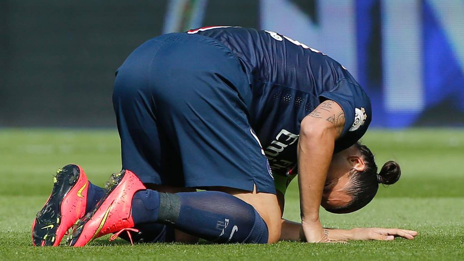FILE - In this Aug.16, 2014 file photo, Paris Saint Germain's Swedish Zlatan Ibrahimovic, kneels on the pitch after being injured, during a French League One soccer match, PSG against Bastia, at the Parc des Princes stadium, in Paris. Instead of catching up with the Premier League or the Bundesliga, a growing catalog of signs indicates that French Ligue 1 clubs _ with the exception of Qatari-owned Paris Saint-Germain _ are slipping further behind rivals in England, Germany, Spain and Italy. Russia, sinking hundreds of billions of rubles of public and private money into the 2018 World Cup and its football clubs, is also now snapping at France’s heels. Armed with an awesome collection of players, owners with seemingly bottomless pockets, and by far the biggest revenues and crowds of Ligue 1, PSG has quickly become a European force. But it could be a long, long time _ perhaps never _ before the likes of Marseille, Saint-Etienne, Monaco or Reims play another European Cup final. (AP Photo/Michel Euler, File)