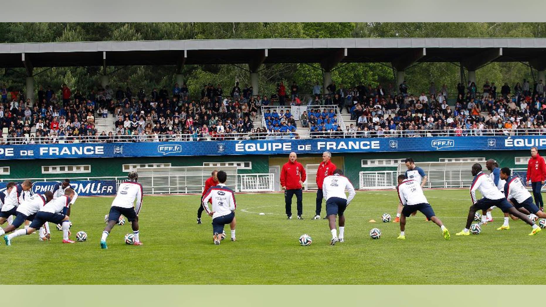 France's soccer players stretch, during a training session at the Clairefontaine training center, outside Paris, Thursday, May 29, 2014. France are preparing for the upcoming soccer World Cup in Brazil starting on 12 June. (AP Photo/Christophe Ena)