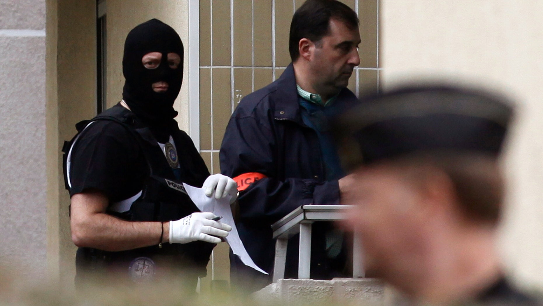 French police officers stand outside a building where authorities discovered bomb-making material after the break up of a suspected terrorist cell last week, in Torcy, east of Paris, Wednesday, Oct. 10, 2012. French police discovered bomb-making materials in an underground parking lot near Paris as part of a probe of an "extremely dangerous terrorist cell" linked to an attack on a kosher grocery, a state prosecutor said Wednesday. (AP Photo/Thibault Camus)