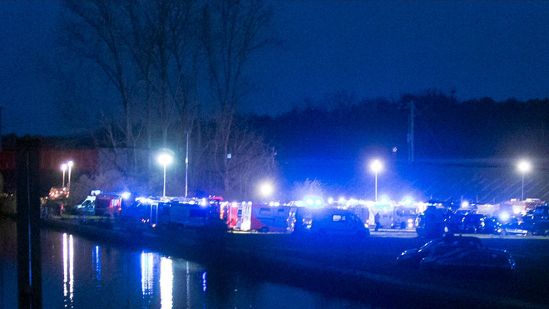Rescue vehicles park between a canal and the railway tracks after a high-speed train derailed in Eckwersheim, near Strasbourg.