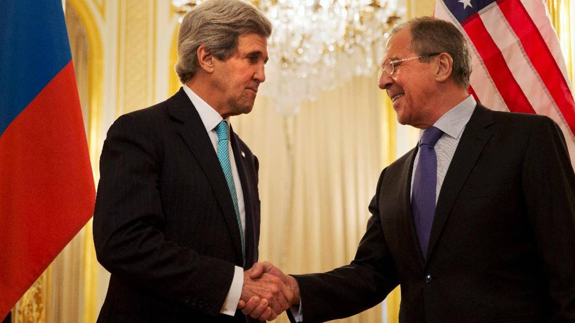 U.S. Secretary of State John Kerry, left, shakes hands with Russian Foreign Minister Sergey Lavrov before the start of their meeting at the Russian Ambassador's residence about the situation in Ukraine, in Paris Sunday March 30, 2014. Kerry traveled to Paris for a last minute meeting with Lavrov. (AP Photo/Jacquelyn Martin, Pool)