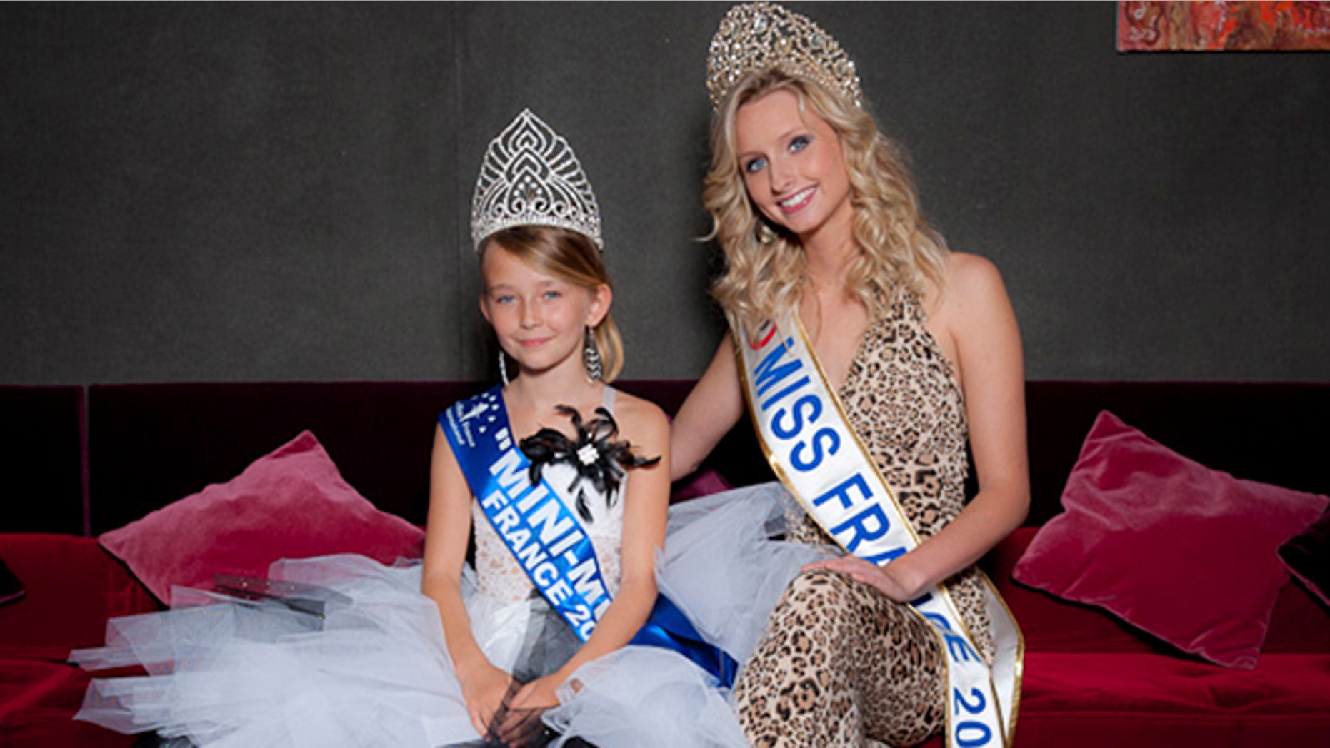 This undated photo provided by the Mini Miss committee shows Oceane Scharre, 10, elected Mini Miss France 2011, left, and Miss France 2011 Mathilde Florin. France's Senate voted Tuesday night, Sept. 17, 2013, to ban beauty pageants for children under 16, in an effort to protect children especially girls from being sexualized too early.