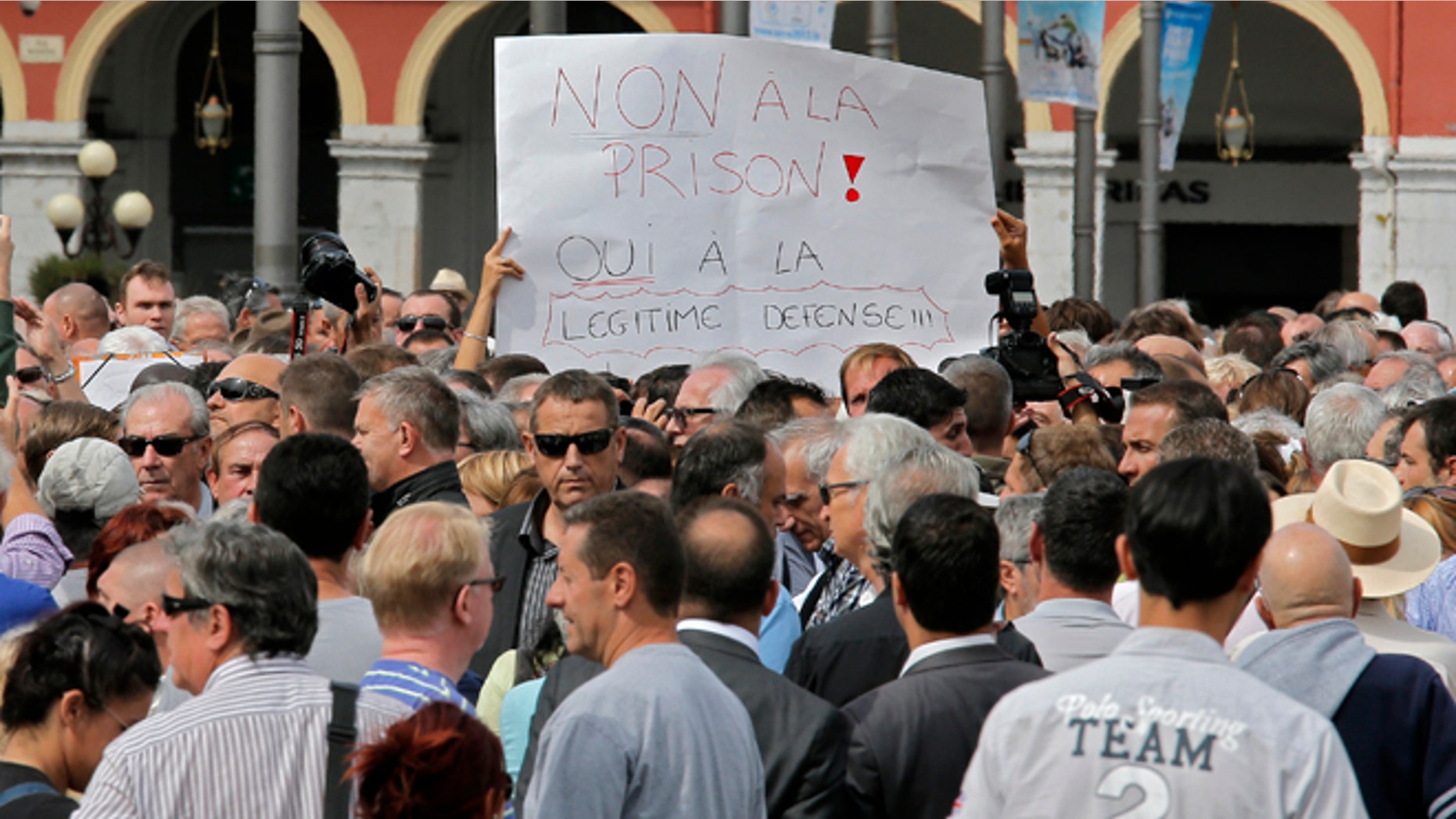 Sept. 16, 2013: Nice citizens, holden a banner writing "No in jail, Yes to self defense", take part in a rally supporting Stephan Turk in Nice southeastern France.