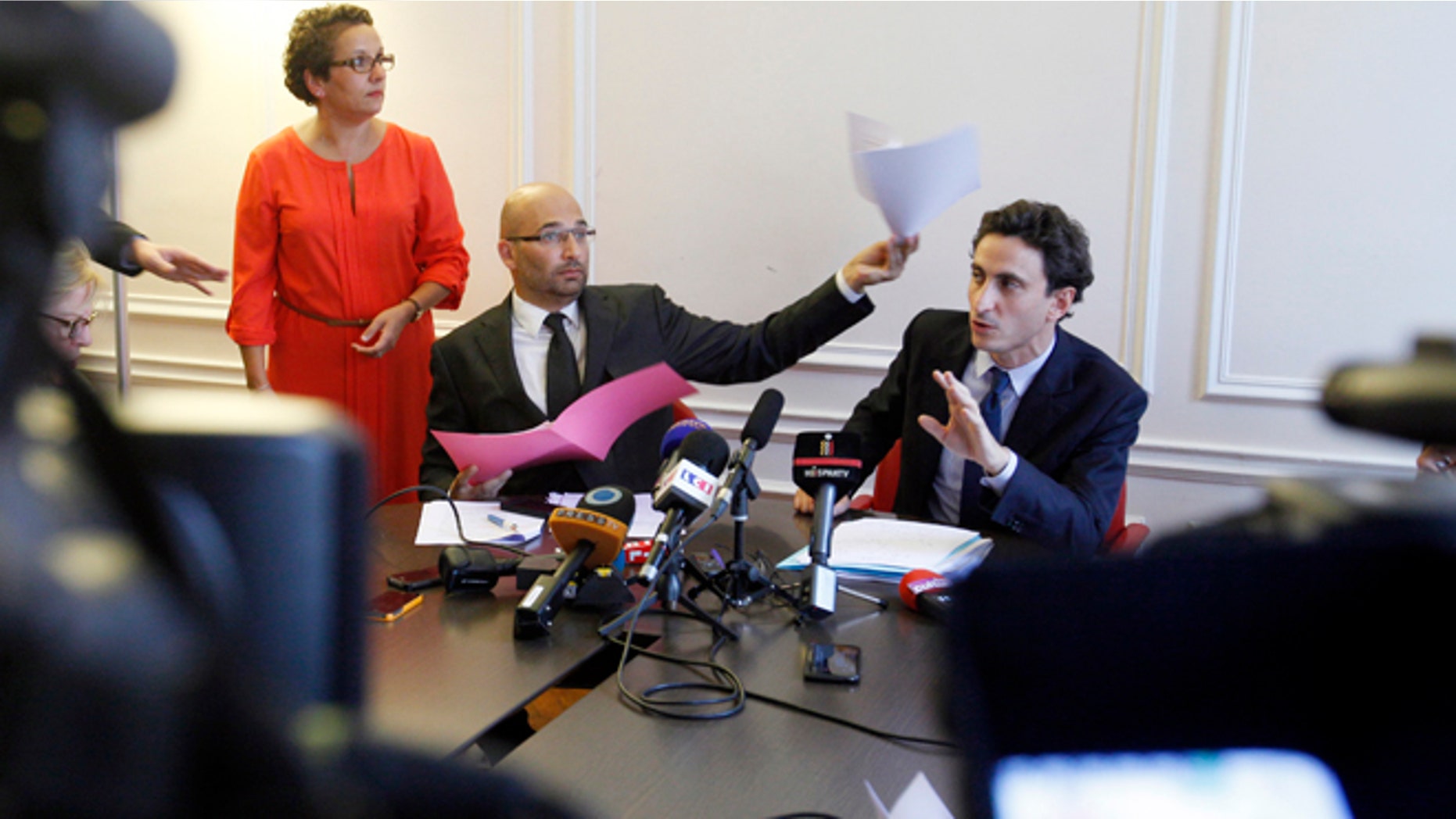 Oct. 2, 2013: Lawyers acting for the plaintiff, Slim ben Achour, left, and Felix de Belloy talk during a press conference in Paris.