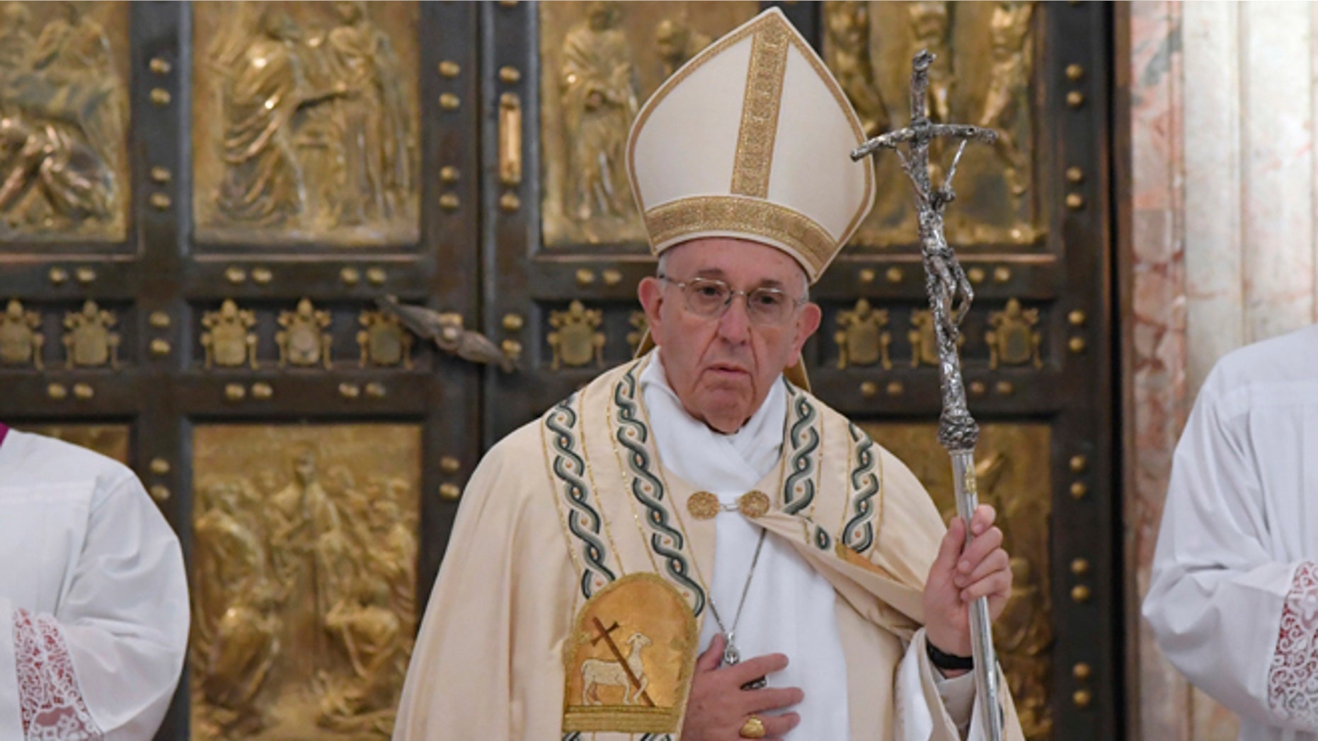 Pope Francis leaves after closing the Holy Door of St. Peter's Basilica at the Vatican, Sunday, Nov. 20, 2016. Pope Francis has pulled shut the Holy Door of St. Peter's Basilica, formally ending the Holy Year of Mercy he declared to highlight that virtue. (Tiziana Fabi/pool photo via AP)
