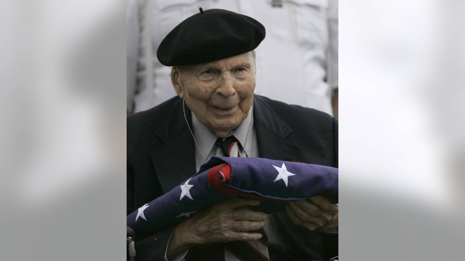 Frank Buckles receives an American flag during Memorial Day activities at the National World War I Museum in Kansas City, Mo. in May of 2008. Buckles died early Sunday, Feb. 27, 2011 of natural causes in his home in Charles Town, W.Va. (AP Photo/Charlie Riedel)