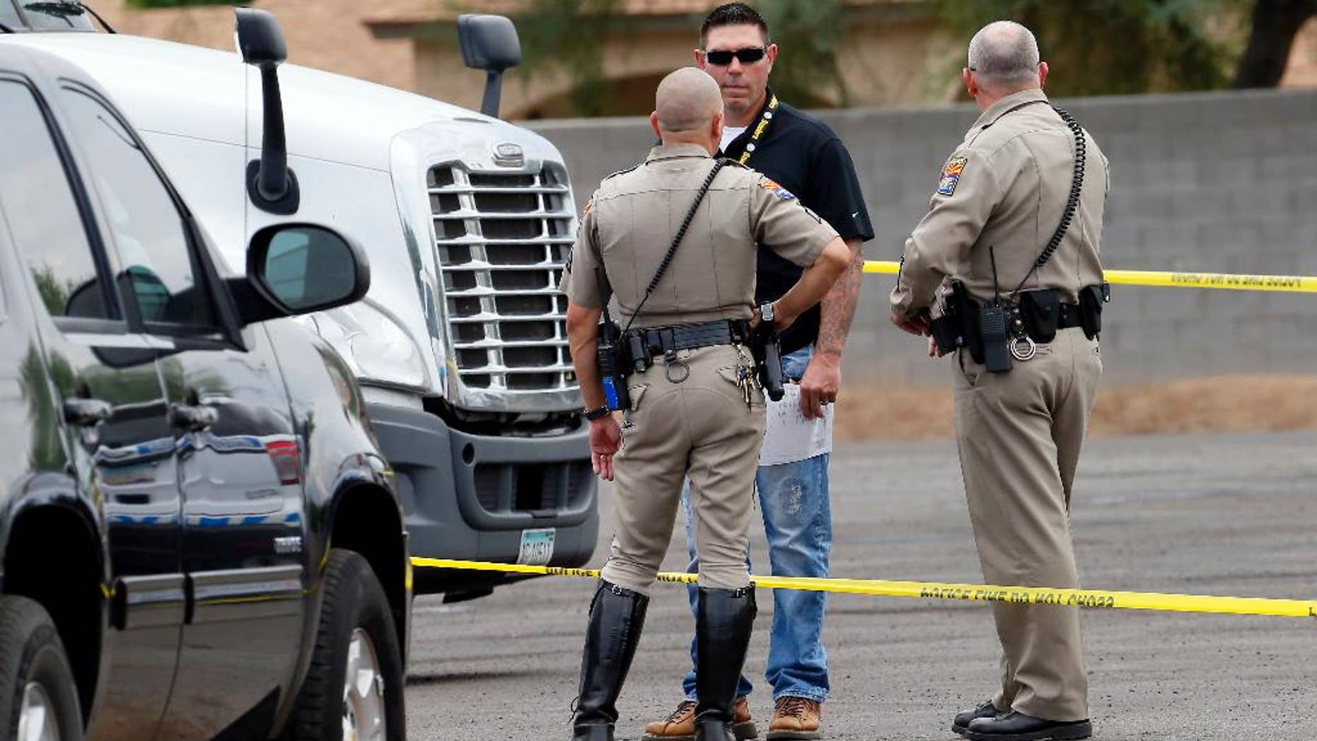 A sign displaying the shooter tip line sits above the cars on the Interstate 10 and 7th Streets, Thursday, Sept. 10, 2015 in Phoenix. The search for a suspect in a string of Phoenix freeway shootings took on a frenzied pace Thursday, with a panicked public flooding a police hotline with tips. Police confirmed one of these reports as a shooting, raising to 11 the number of vehicles struck on Phoenix-area freeways since Aug. 29. (Patrick Breen/The Arizona Republic via AP) MARICOPA COUNTY OUT; MAGS OUT; NO SALES; MANDATORY CREDIT