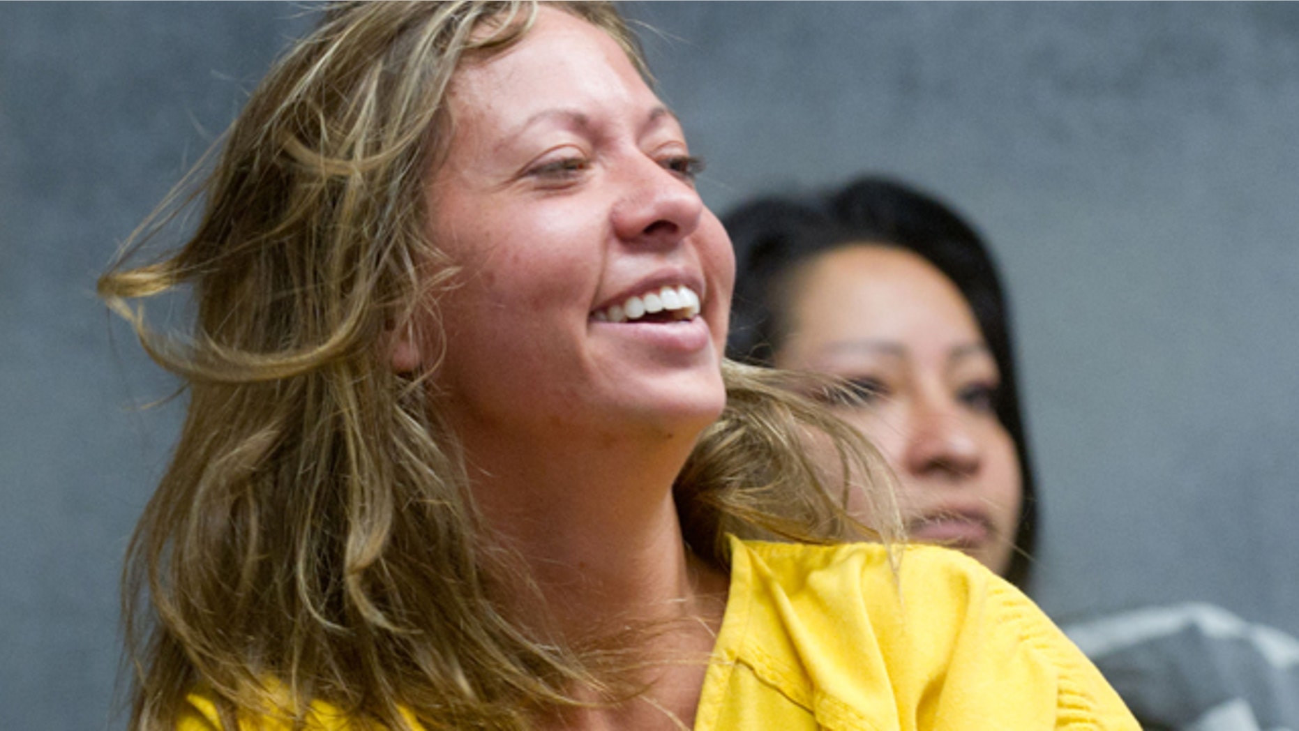 Aug. 11: Lee Grace Dougherty, 29, laughs while awaiting advisement at the Pueblo County Sherrif's Office detention center.