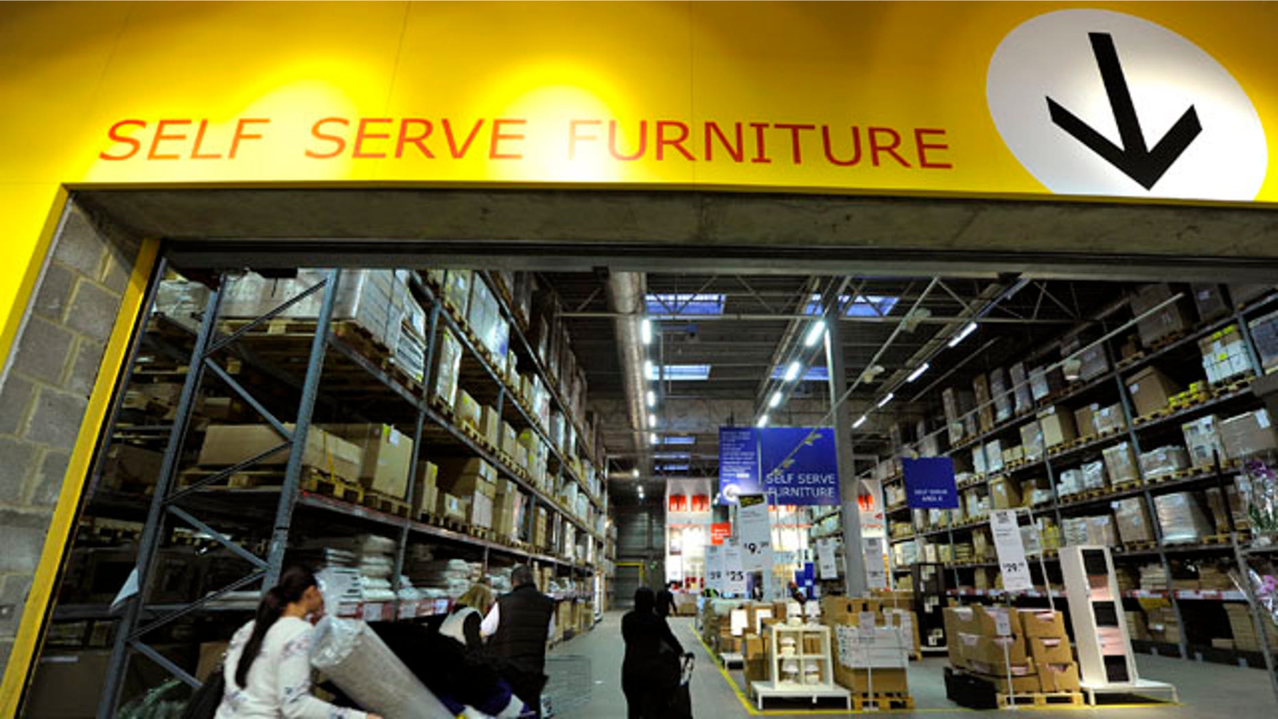 Shoppers push trolleys into Ikea's self service area at the Wembley branch of the Swedish international furniture and home accessories company in west London October 15, 2010. REUTERS/Toby Melville (BRITAIN - Tags: BUSINESS)