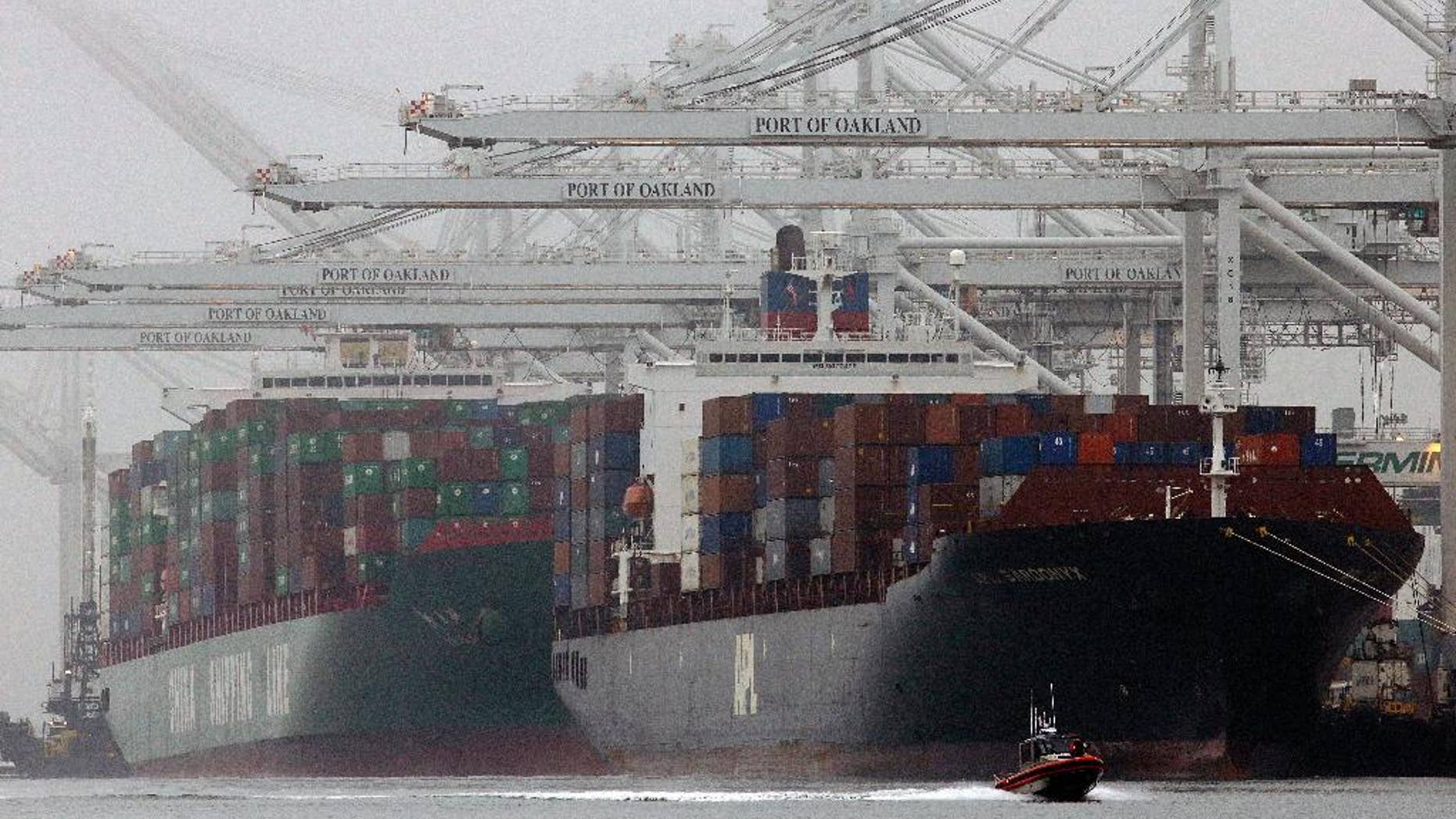 FILE - In this Wednesday, Oct. 23, 2013, file photo, container ships wait to be off-loaded in a thick fog at the Port of Oakland in Oakland, Calif. The Commerce Department releases fourth-quarter gross domestic product on Friday, Feb. 28, 2014. (AP Photo/Ben Margot, File)