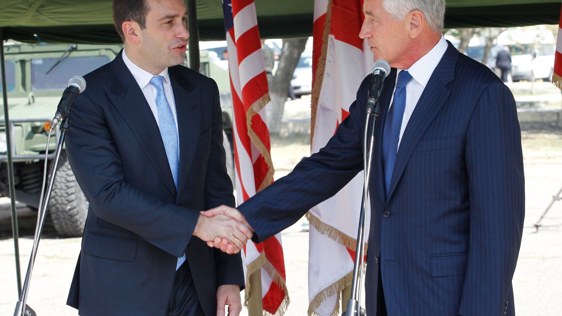 Sept. 7, 2014: Georgia's Defense Minister Irakli Alasania, left, and U.S. Defense Secretary Chuck Hagel shake hands at the Krtsanisi military training base outside Tbilisi Georgia.