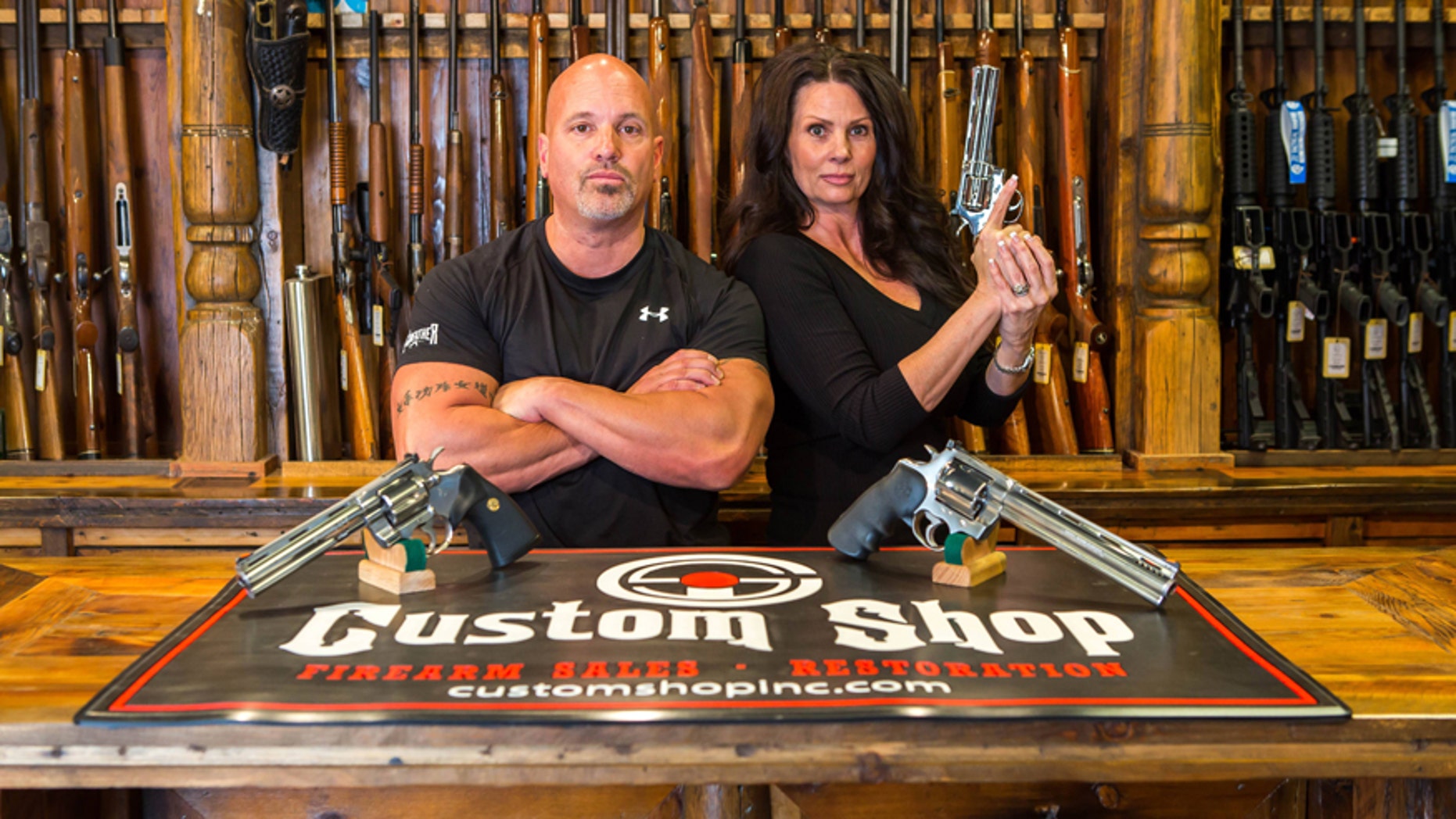 Lou Tuminaro and his wife Theresa of "The Gunfather" pose in their Hamilton, Montana store The Custom Shop.