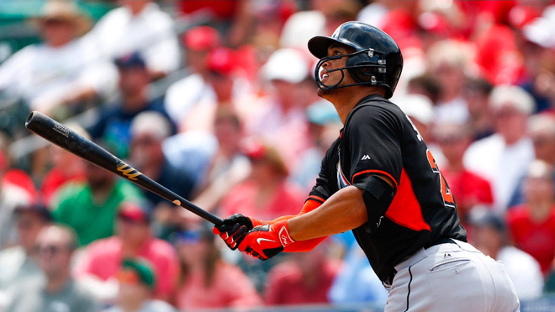 March 26: Miami Marlins' Giancarlo Stanton follows through with a home run in the first inning of an exhibition spring training baseball game against the St. Louis Cardinals.