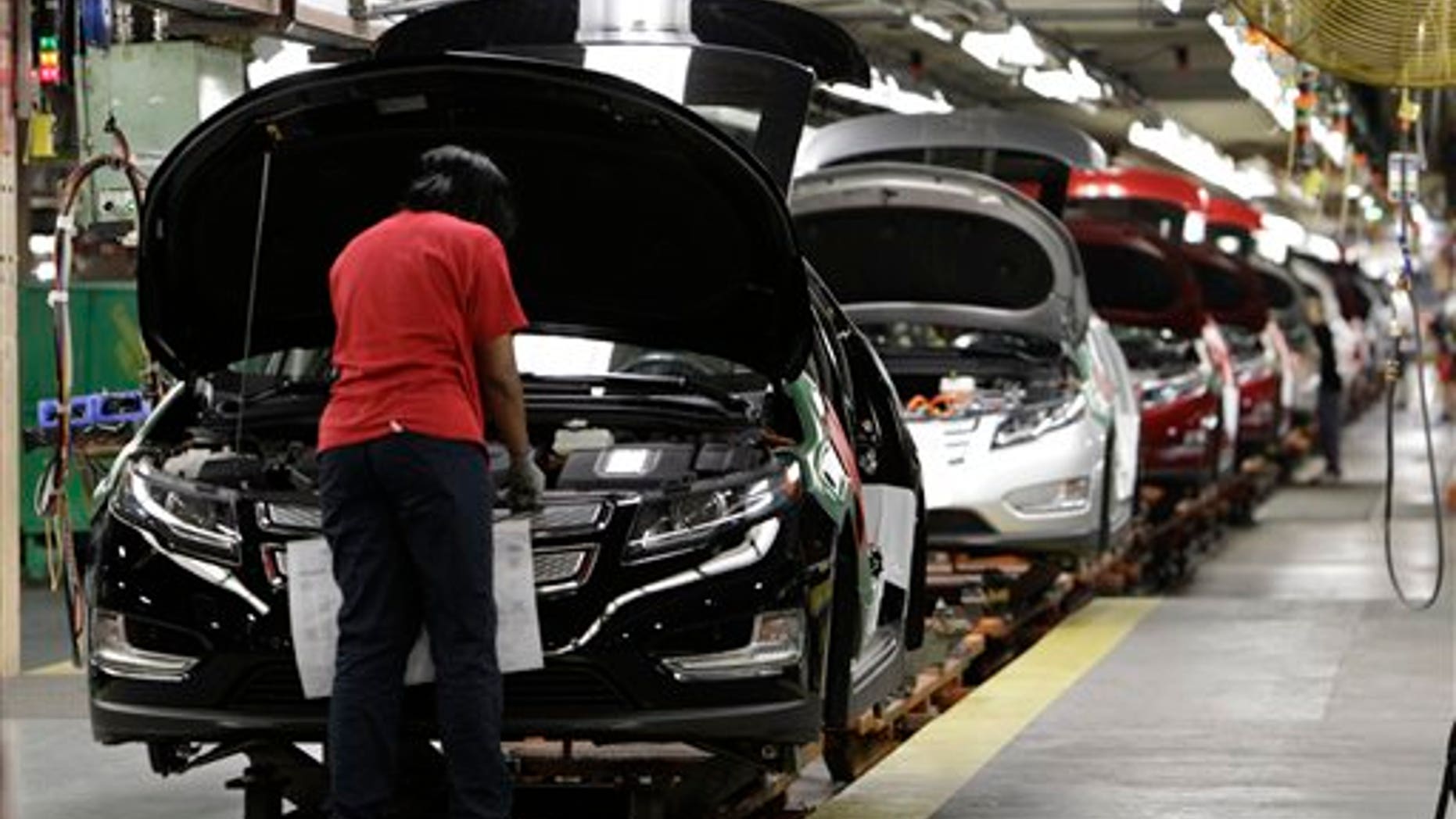 July 27: Assembly worker Julaynne Trusel works on a Chevrolet Volt at the General Motors Hamtramck Assembly plant in Hamtramck, Michigan.