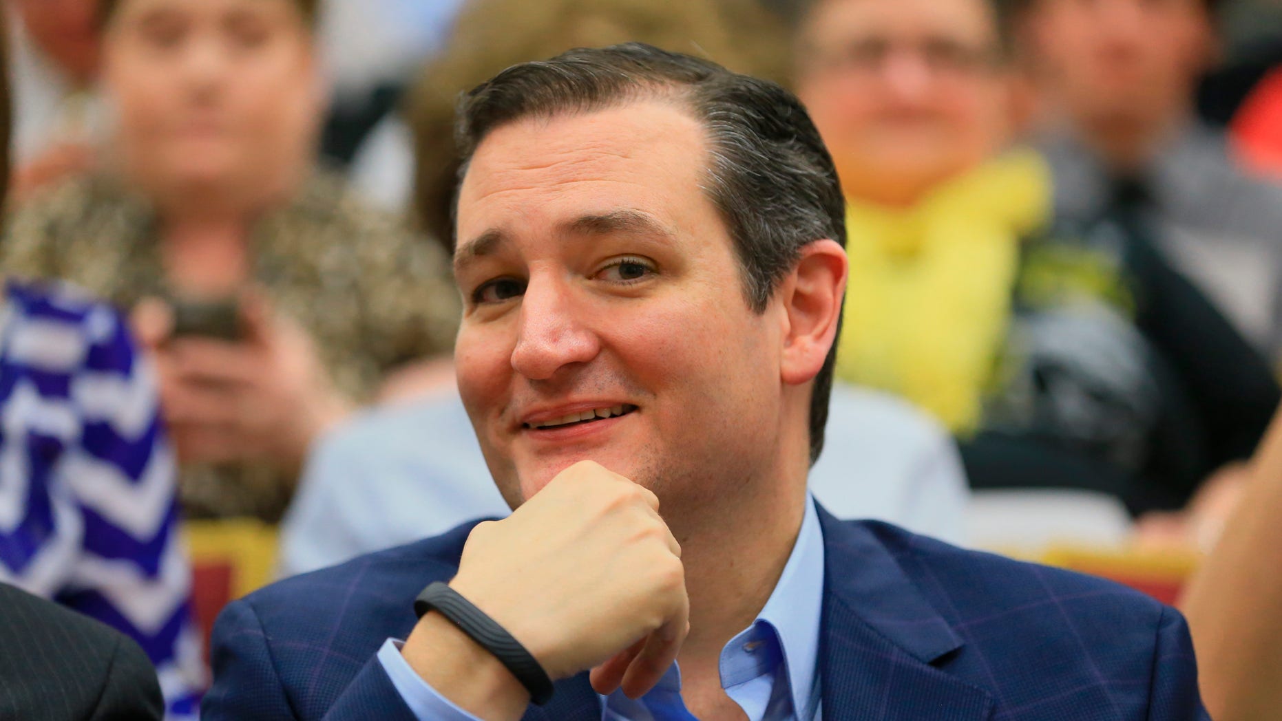 Republican presidential candidate Sen. Ted Cruz, R-Texas, smiles as he sits in the front row as he waits to be introduced before speaking at a town hall event at Morningside College in Sioux City, Iowa, Wednesday, April 1, 2015. (AP Photo/Nati Harnik)