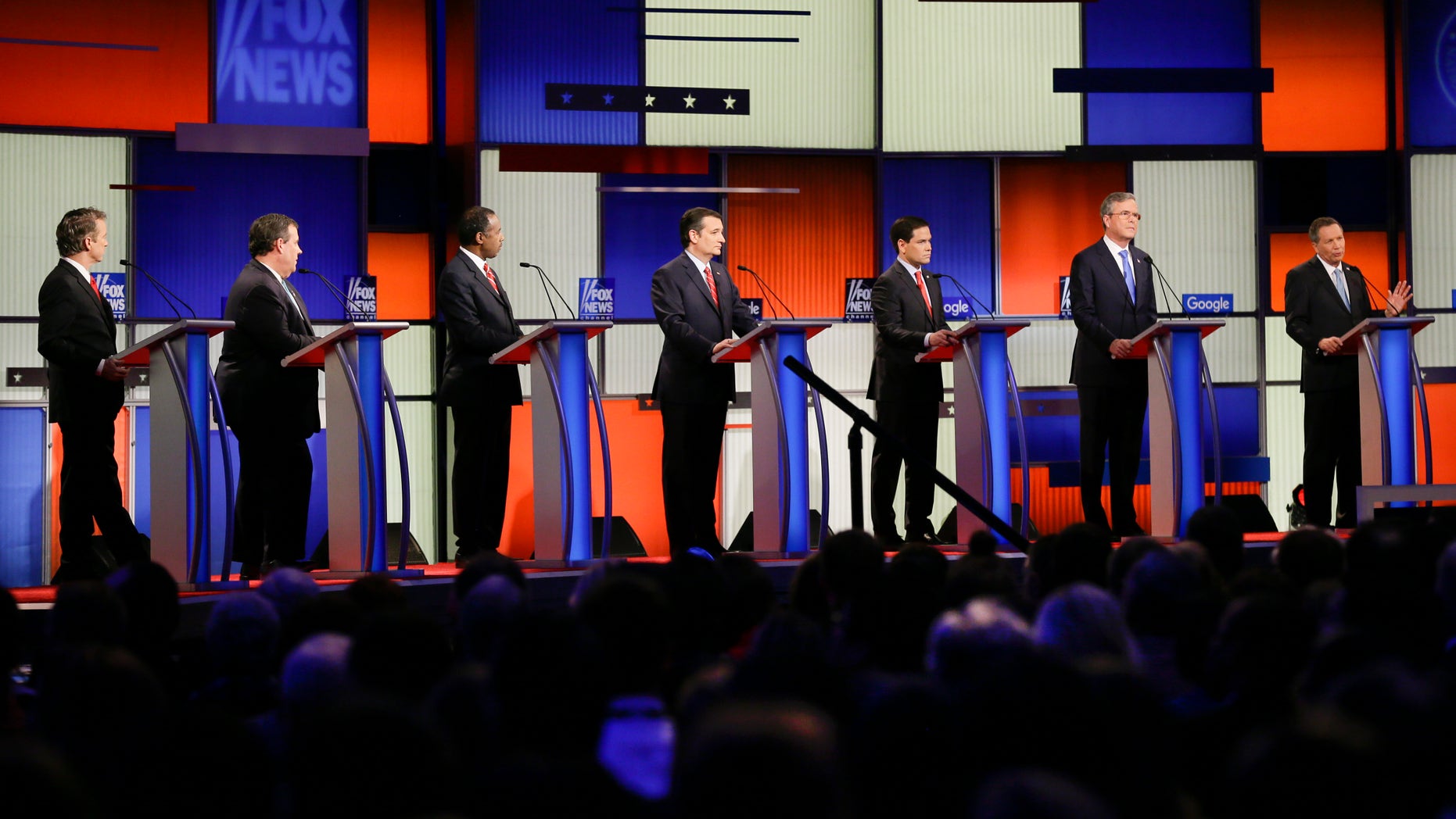 Republican presidential candidate Ohio Gov. John Kasich, right, answers a question as (L-R) Sen. Rand Paul, R-Ky., New Jersey Gov. Chris Christie, retired neurosurgeon Ben Carson, Sen. Ted Cruz, R-Texas, Sen. Marco Rubio, R-Fla., and former Florida Gov. Jeb Bush listen during a Republican presidential primary debate, Thursday, Jan. 28, 2016, in Des Moines, Iowa. (AP Photo/Charlie Neibergall)