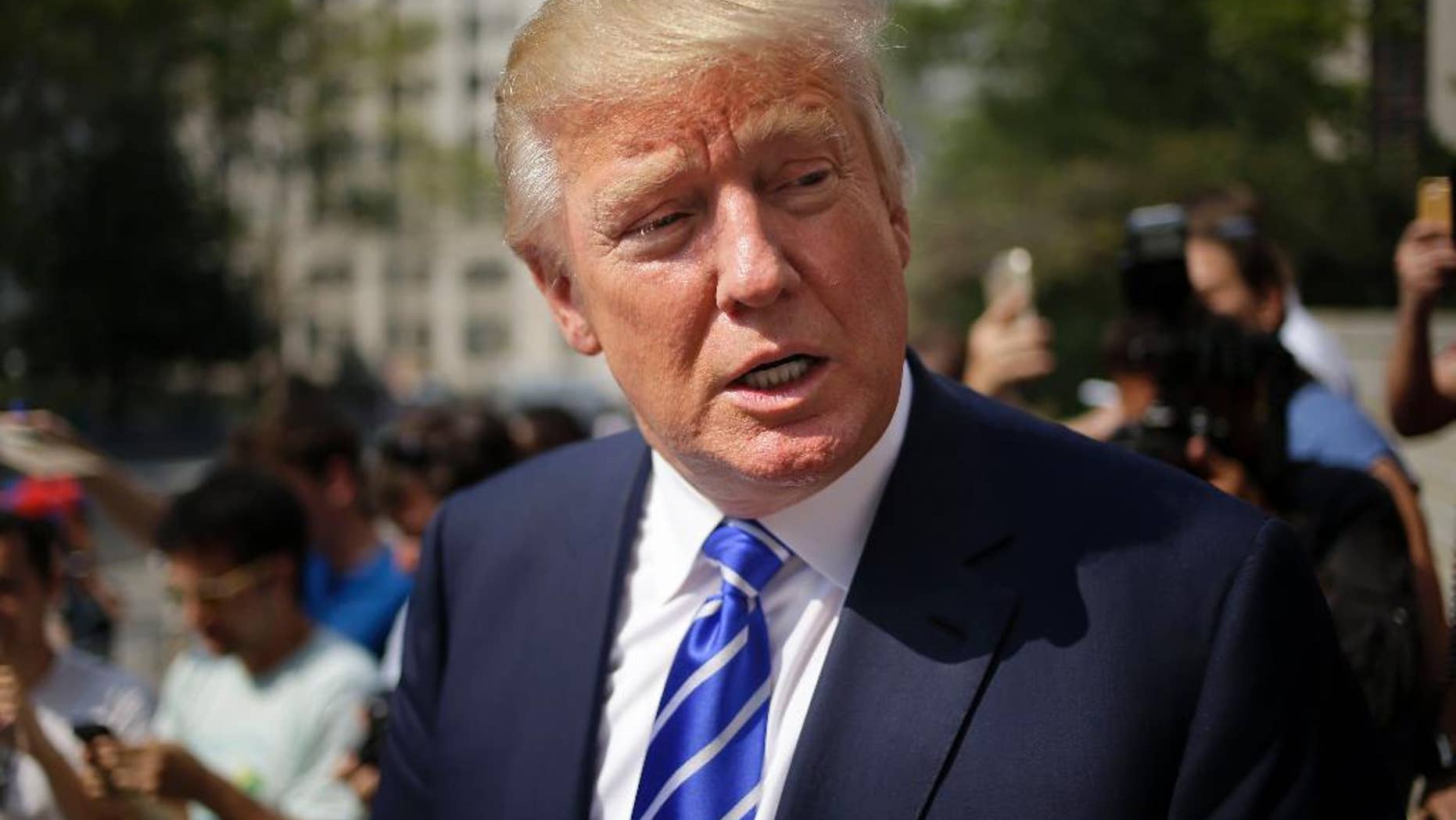 Republican presidential candidate Donald Trump leaves the courthouse after serving on jury duty in New York, Monday, Aug. 17, 2015. The Republican presidential candidate reported for jury duty in Manhattan on Monday and spent much of the day like everyone else, filling out forms and wondering whether he would get picked. (AP Photo/Seth Wenig)