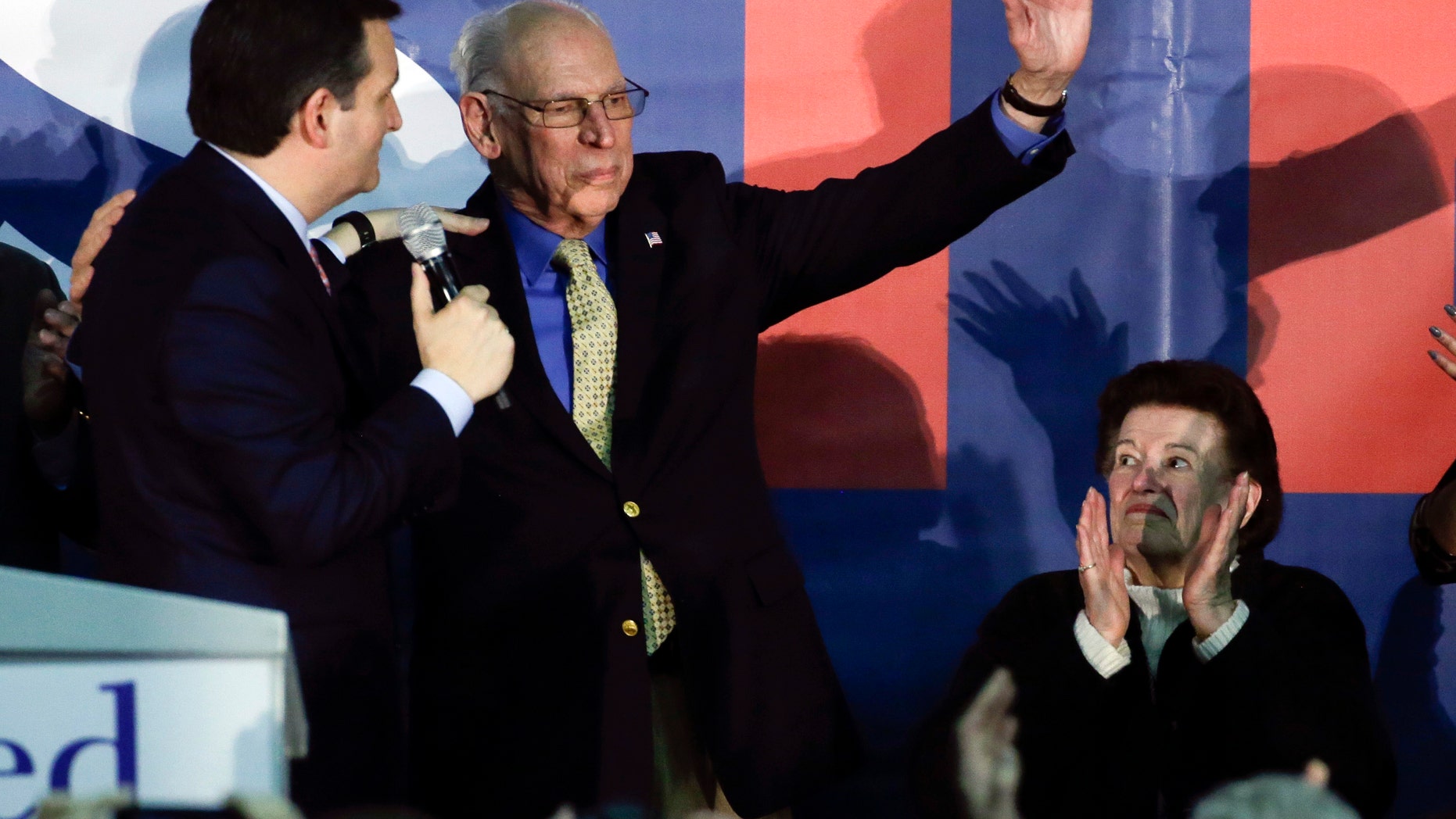 FILE - In this Feb. 1, 2016 file photo, Republican presidential candidate, Sen. Ted Cruz, R-Texas greets his father Rafael as his mother Eleanor Darragh applauds during a rally in Des Moines, Iowa. Republican front-runner Donald Trump rehashed claims Tuesday that his rival Ted Cruzs father has links to President John F. Kennedys assassin Lee Harvey Oswald. (AP Photo/Chris Carlson, File)