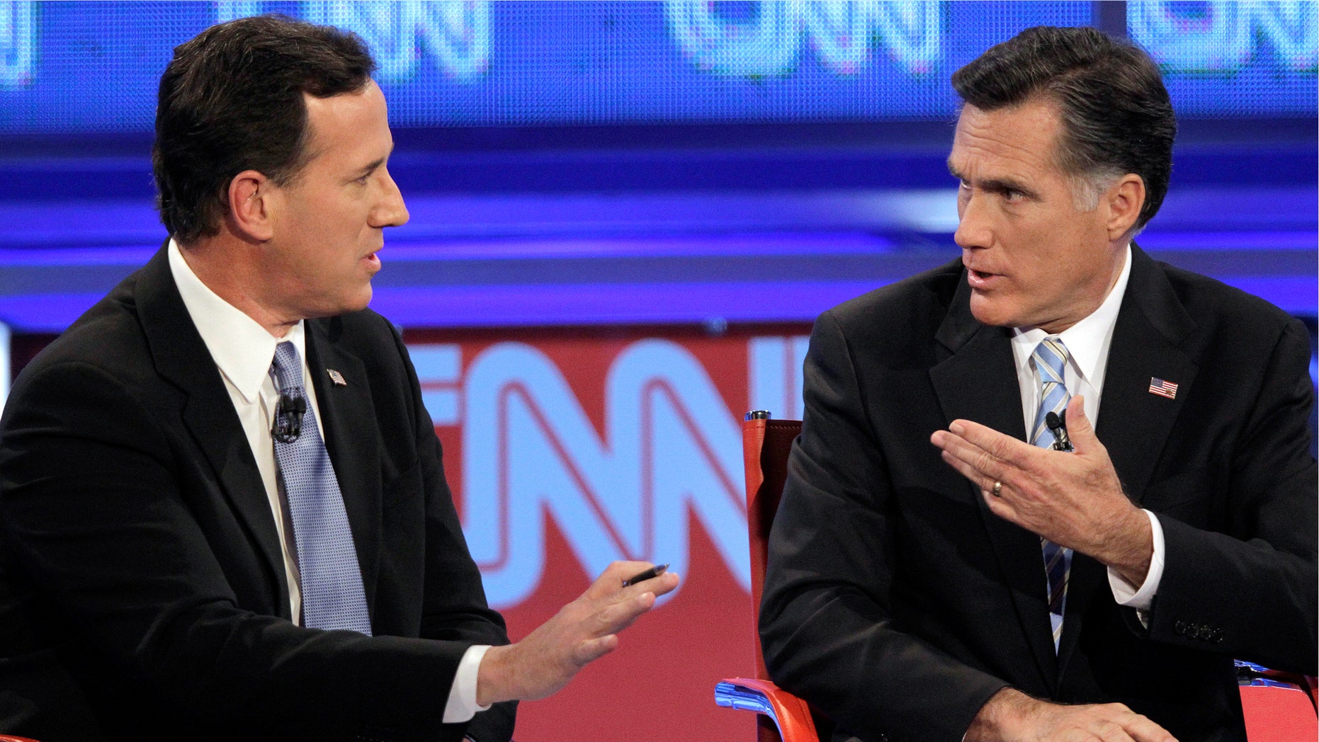 Republican presidential candidate, former Massachusetts Gov. Mitt Romney, right, debate a point with former Pennsylvania Sen. Rick Santorum during a Republican presidential debate Wednesday, Feb. 22, 2012, in Mesa, Ariz. (AP Photo/Jae C. Hong)